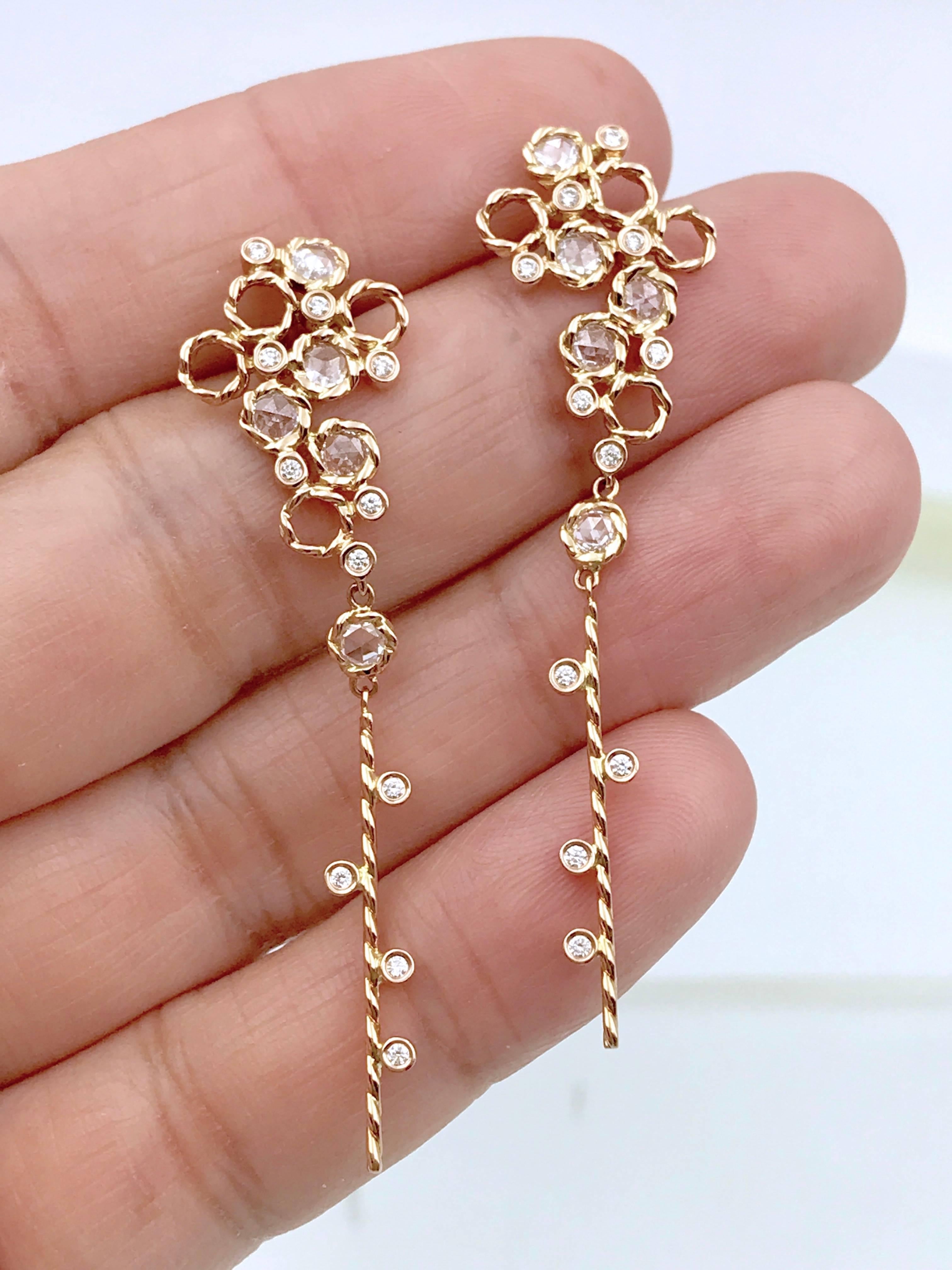 Hera earrings are from JeweLyrie's Allongé collection,  each featuring 5 signature twist bezel set rose cut diamonds and small bezels set full cut diamonds, randomly arranged among twist rings. The cluster resembles the happy champagne bubbles. A