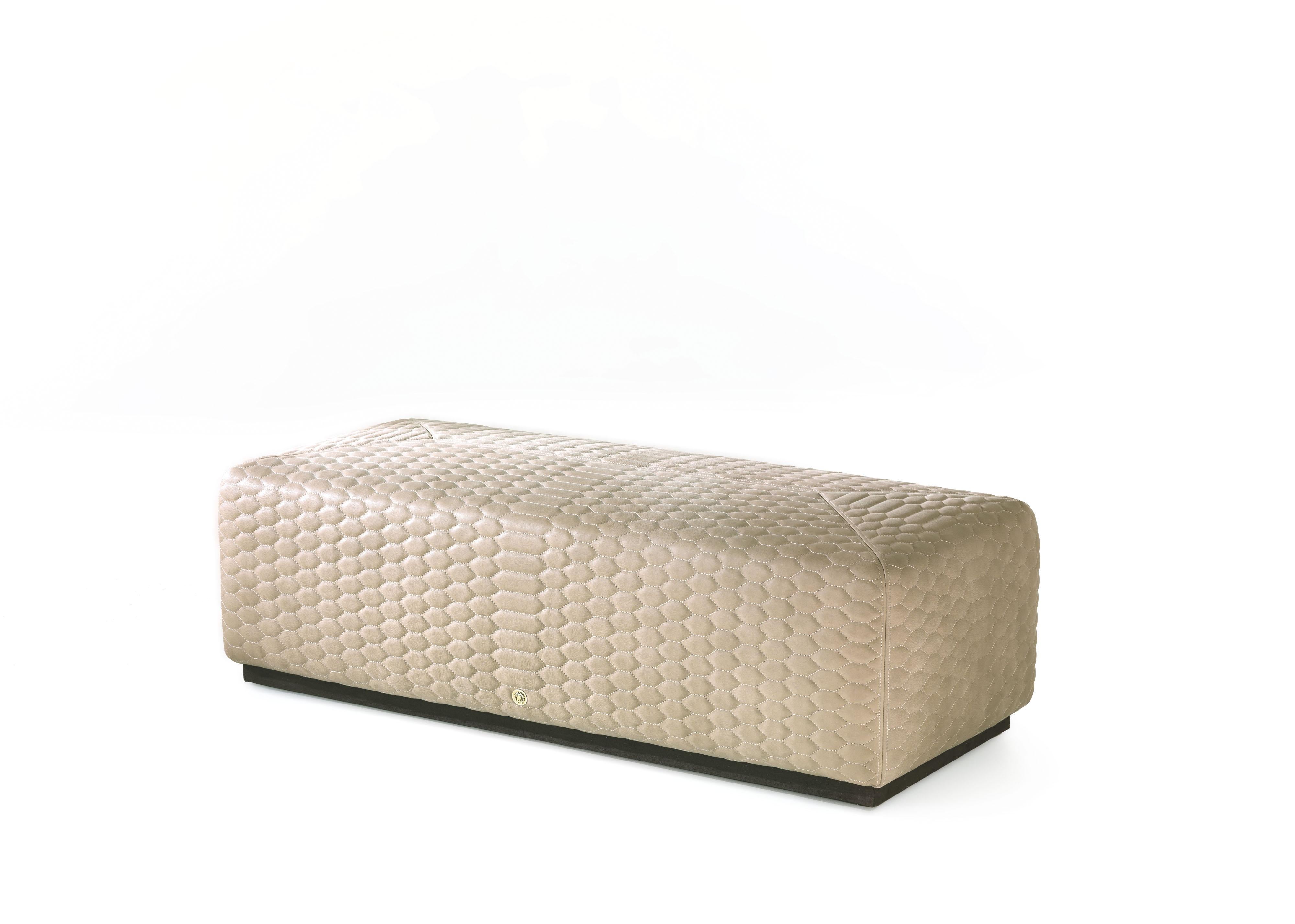 Elegant and modern lines for the Hera pouf upholstered with precious Charlize silk printed with typical Roberto Cavalli patterns.
Hera Pouf structure in poplar wood and foam. Upholstery in hexagonal quilted leather CAT. A Sauvage COL. Ghiaia.