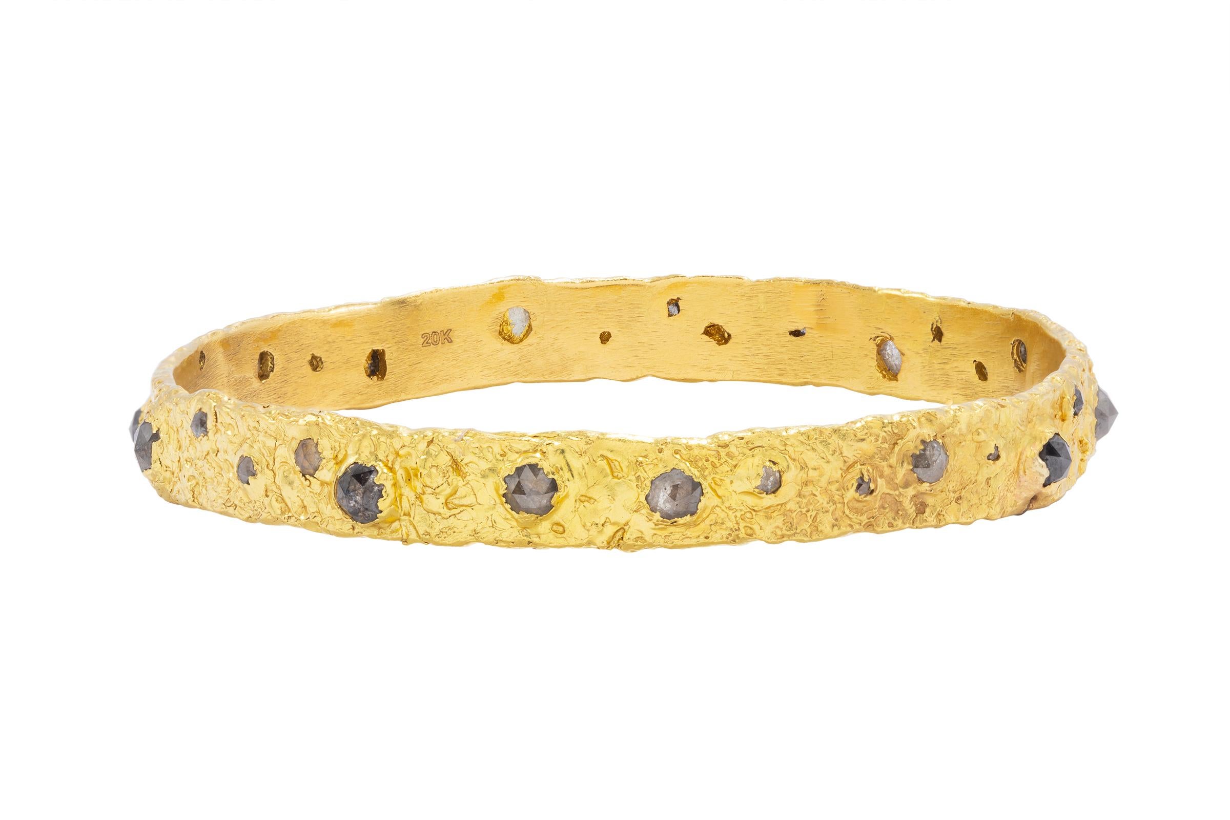 The Hera 20k Gold Bangle with Salt and Pepper Diamonds set beautifully around this gorgeous piece. The Hera is hand made, one of a kind and features Tagili Designs signature finish. Part of The Goddess Collection. The ultimate in feminine power.