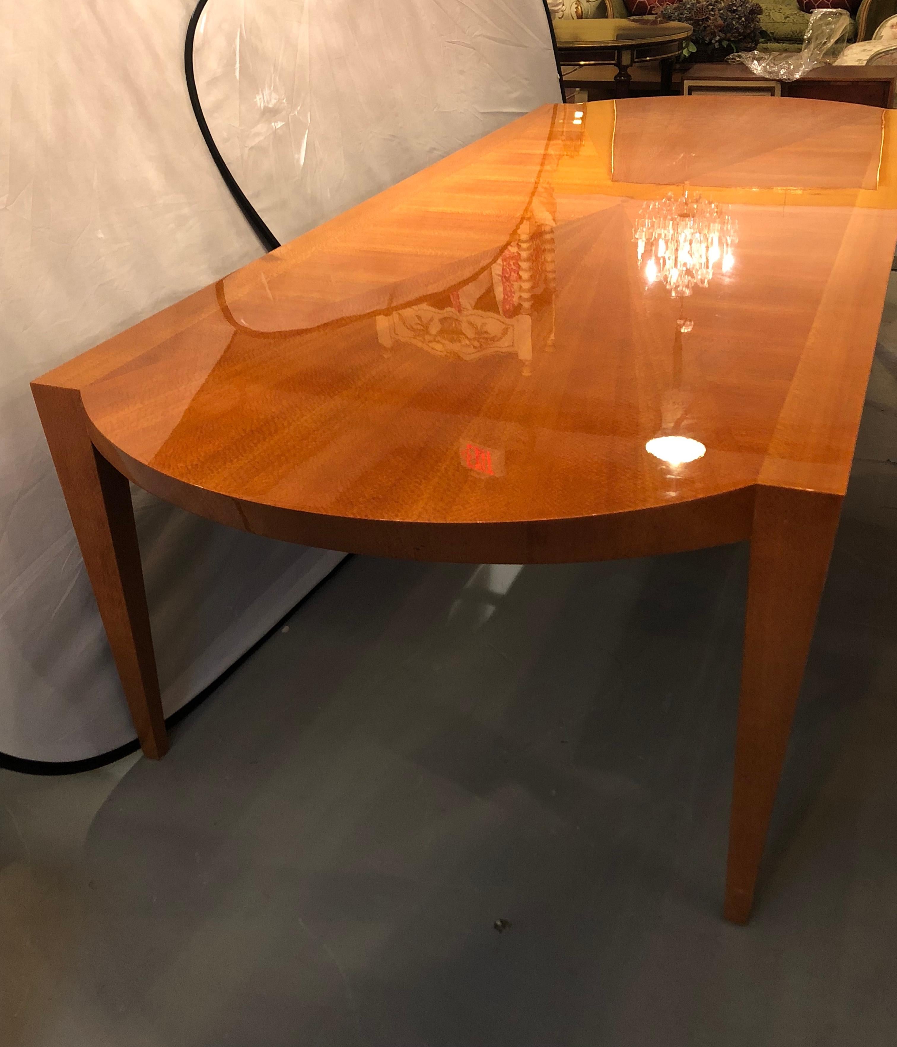 Mid-Century Modern style Heraldic Dakota Jackson Australian Lacewood dining or conference table. Arched aprons and tapered trapezoidal legs. This table is in very nice condition with a fine sunburst top. The owner having paid in excess of $25,000 to
