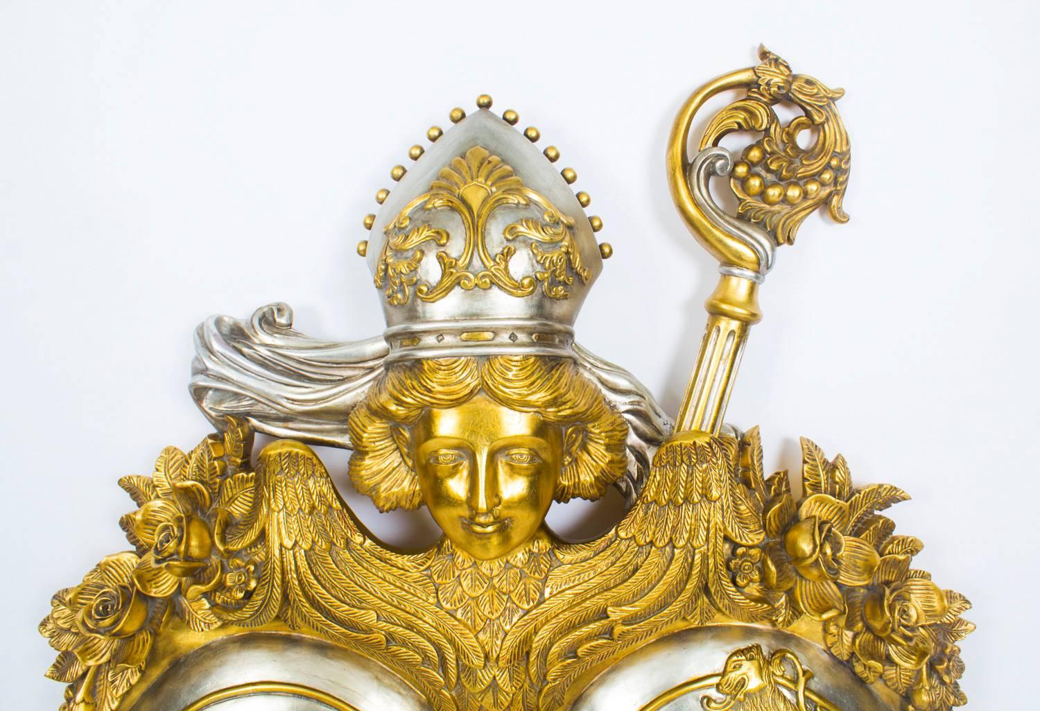 A highly decorative large gilded carved mahogany antique Habsburg heraldic coat of arms, late 20th century in date.

This stunning coat of arms consists of a gilded Papal Tiara on a winged angel and Crozier, to the top, with a pair of shields below,