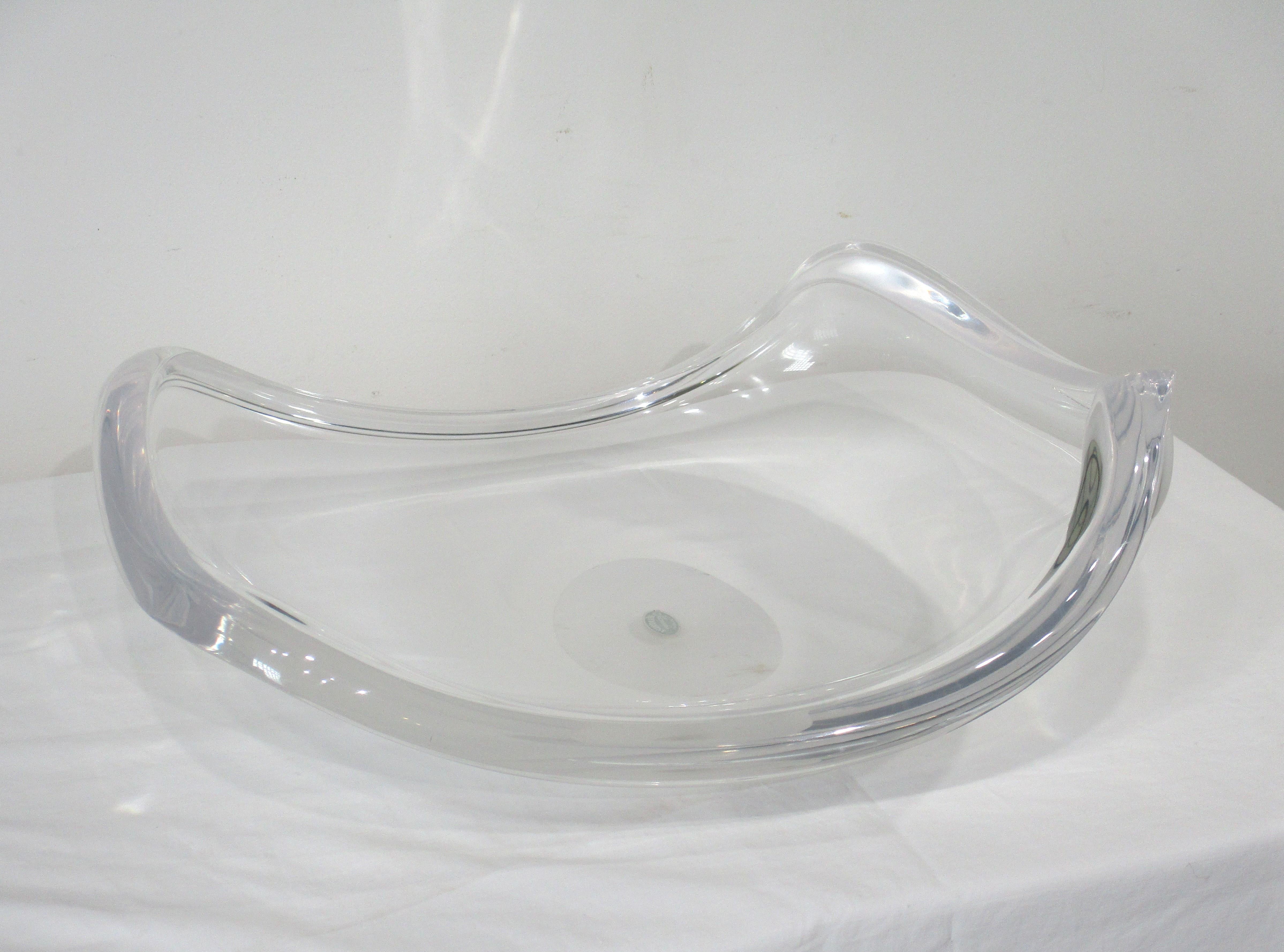A large sized sculptural center piece bowl in thick Lucite with curved edges and upturned sides making this the perfect statement for any mid century table. Designed by Herb Ritts for the Astrolite company produced in the 1950's and still retains