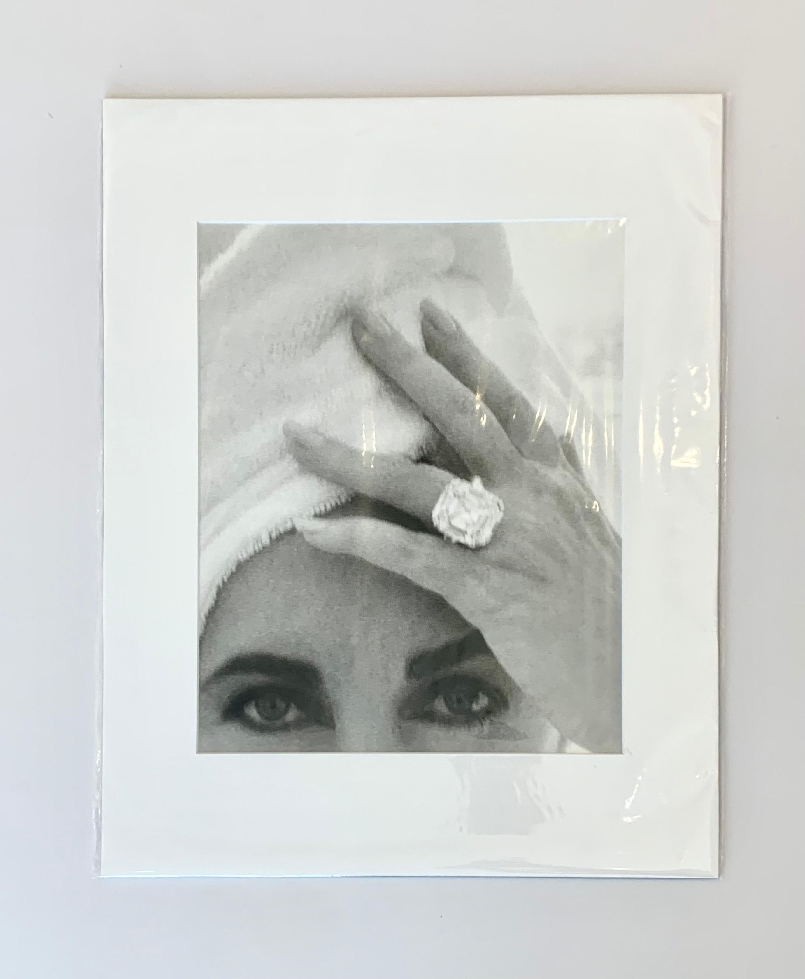 Elizabeth Taylor 1991
by Herb Ritts

American actress and icon, Elizabeth Taylor, poses with towel and diamond ring.

Unframed
Matted
Overall size : 16 x 20