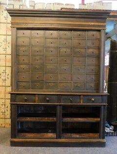Herbalism cabinet with drawers of various sizes and shelves, Italy