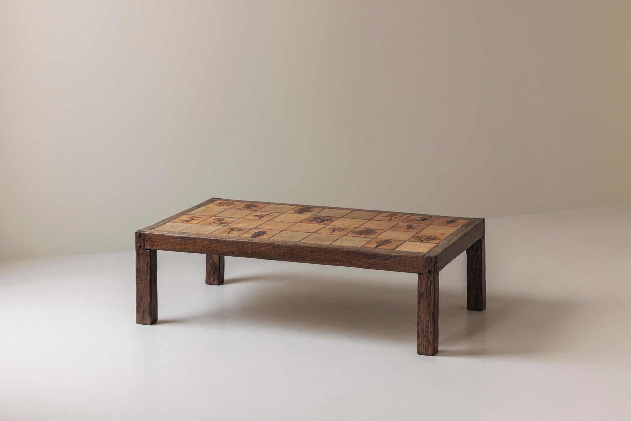 A beautiful example of mid-century French design, this early edition ‘Herbarium’ rectangular coffee table was created by renowned ceramicist Roger Capron in the 1960s. The piece features a solid oak frame paired with a striking ceramic tile