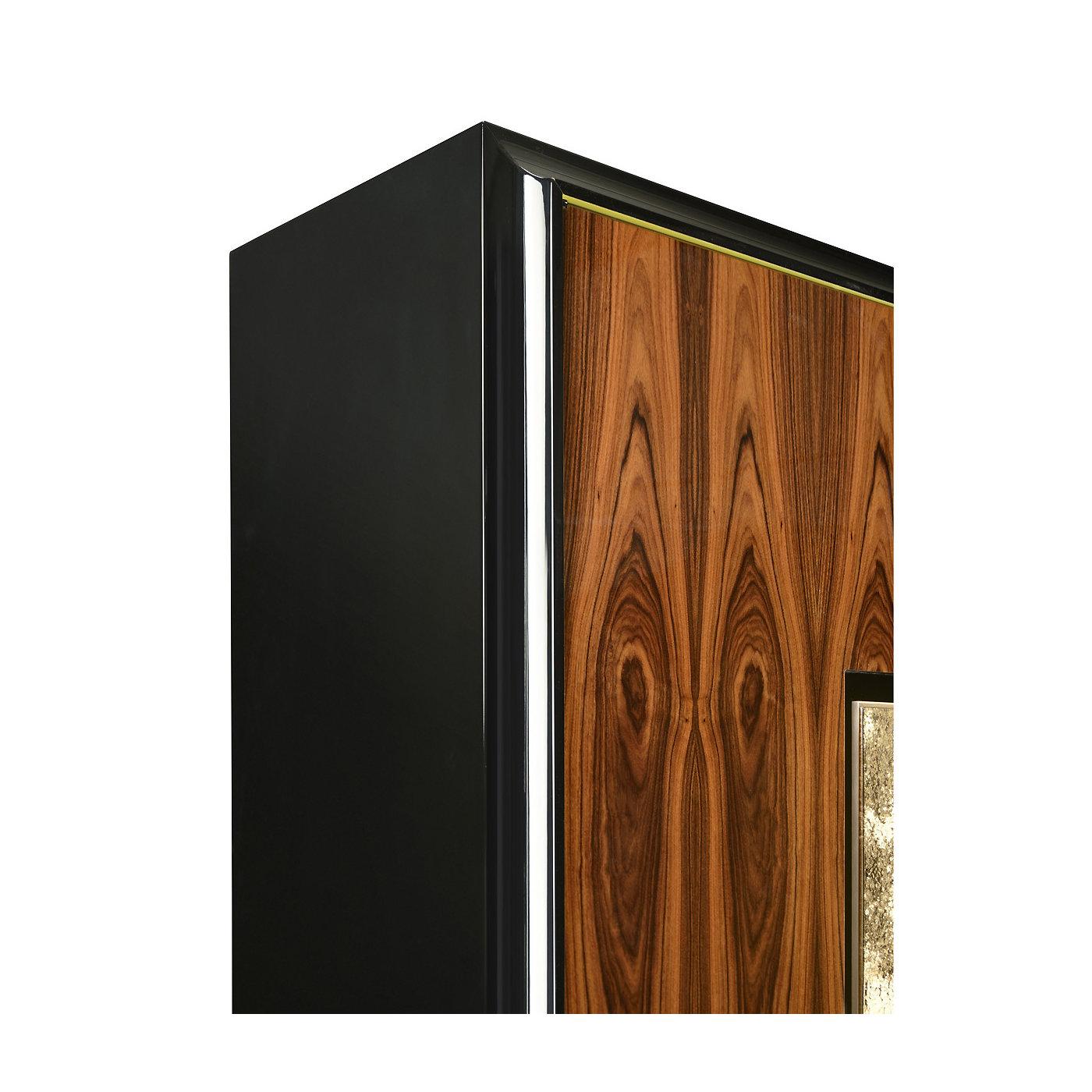 This magnificent cabinet will be an eye-catching addition to any decor, providing a precious storage space and stunning decoration in a living room, entrance, or study. The square silhouette features two doors with a striking veneer showing the