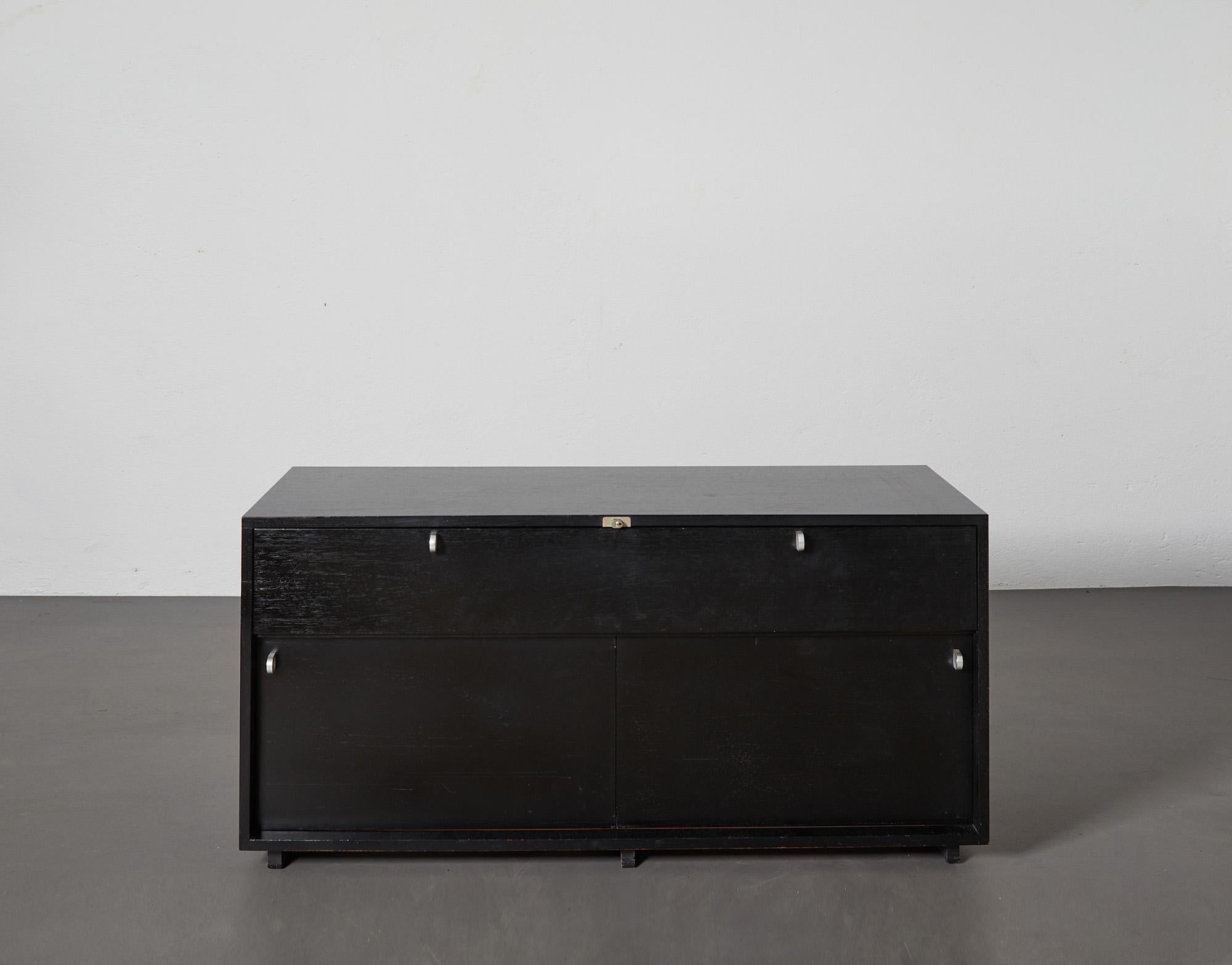 Herbert Hirche Executive Sideboard in black painted wood from Top Series by Christian Holza¨pfel, 1967.
Original key included. Measures: width 133.5 cm, height 63 cm, depth 48.5 cm.

This is a beautiful example the design work of Herbert Hirche: