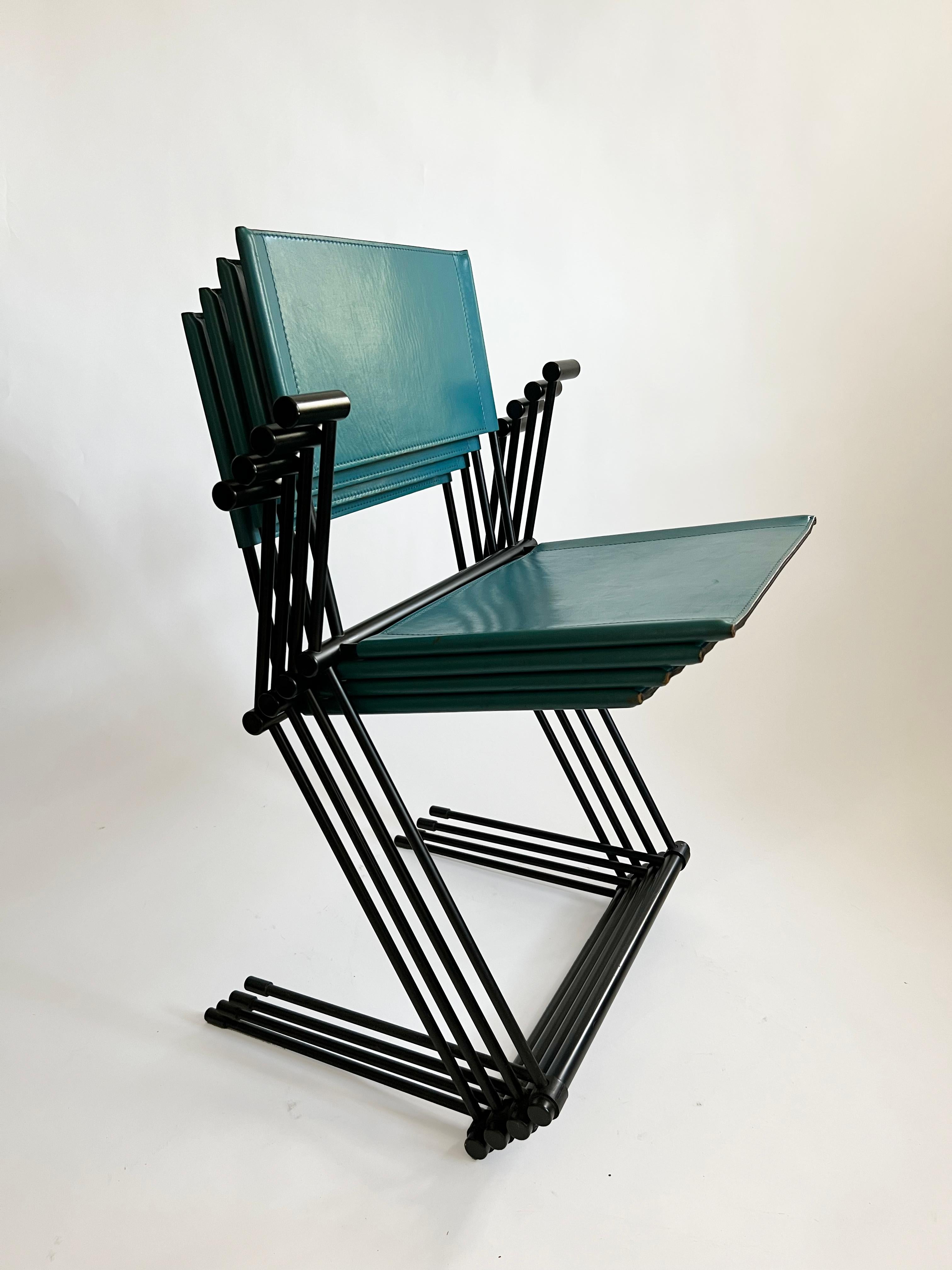 Herbert Ohl designed the ballerina chair in 1991 for Matteo Grassi. These chairs have a black painted metal frame and a blue saddle leather cover with a greenish touch. They are comfortable to sit and perfectly balanced. The chairs show slight signs