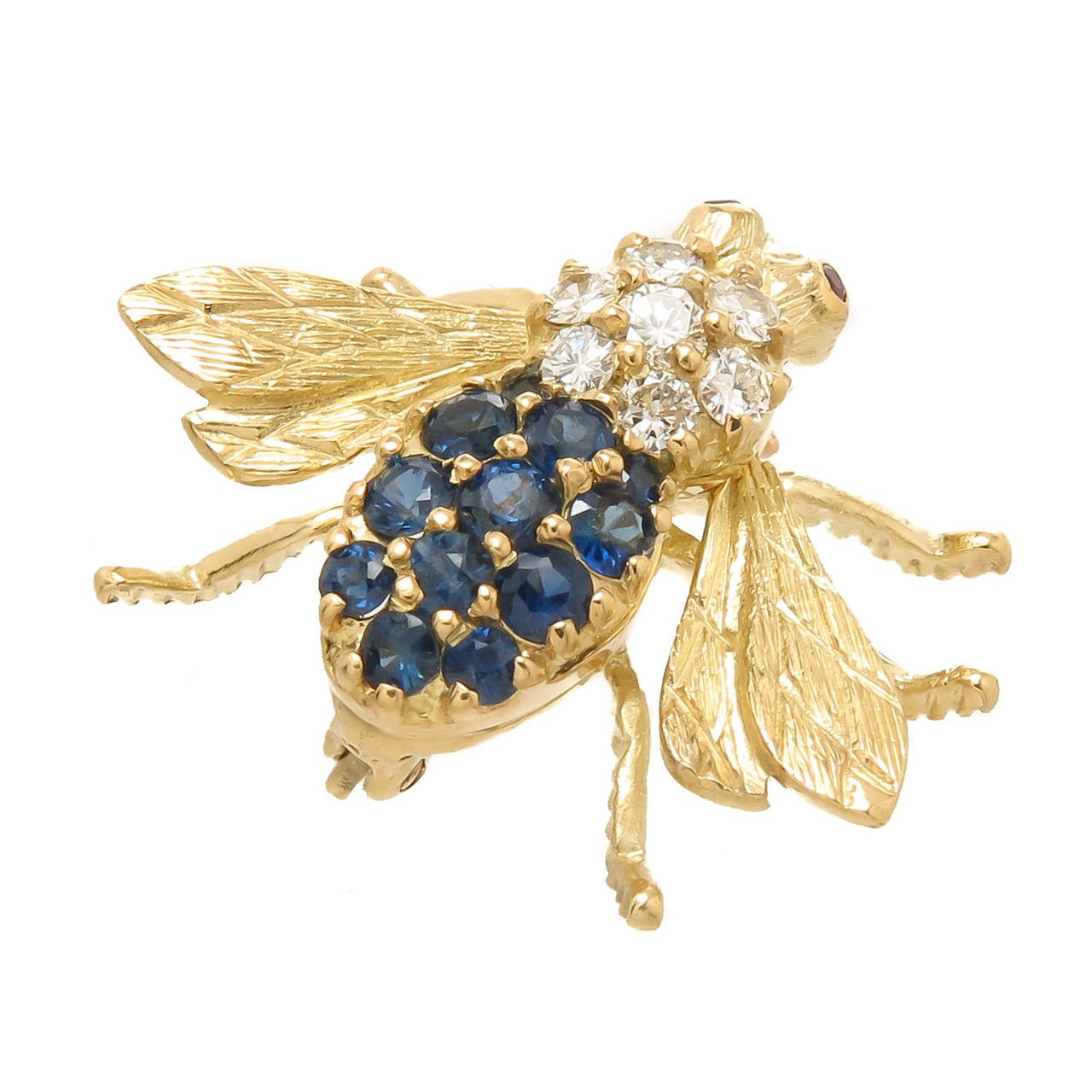 Circa 1980s 18K Yellow Gold, Diamond and Sapphire Bee Brooch by Herbert Rosenthal, measuring 7/8 inch in length and 1 inch from wing tip to tip. Set with Round Brilliant cut Diamonds totaling .25 Carat, further set with numerous Round Brilliant Fine