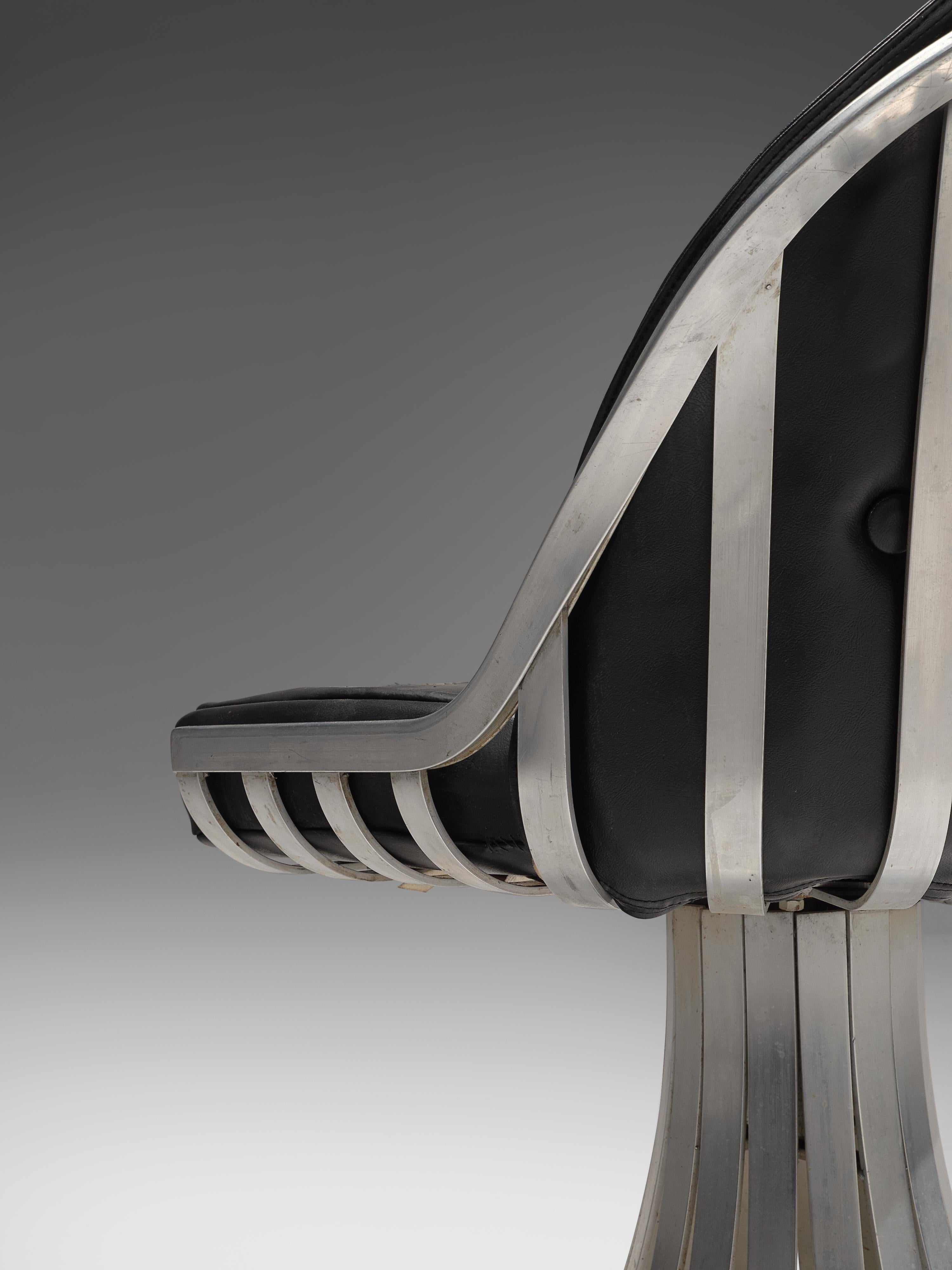 Herbert Saiger, dining chair, black upholstery and aluminum, United States, 1960s.

This stylized chair was designed by Herbert Saiger in the 1960s. Originally intended as outdoor patio furniture, it fits an indoor setting as well. The pedestal foot