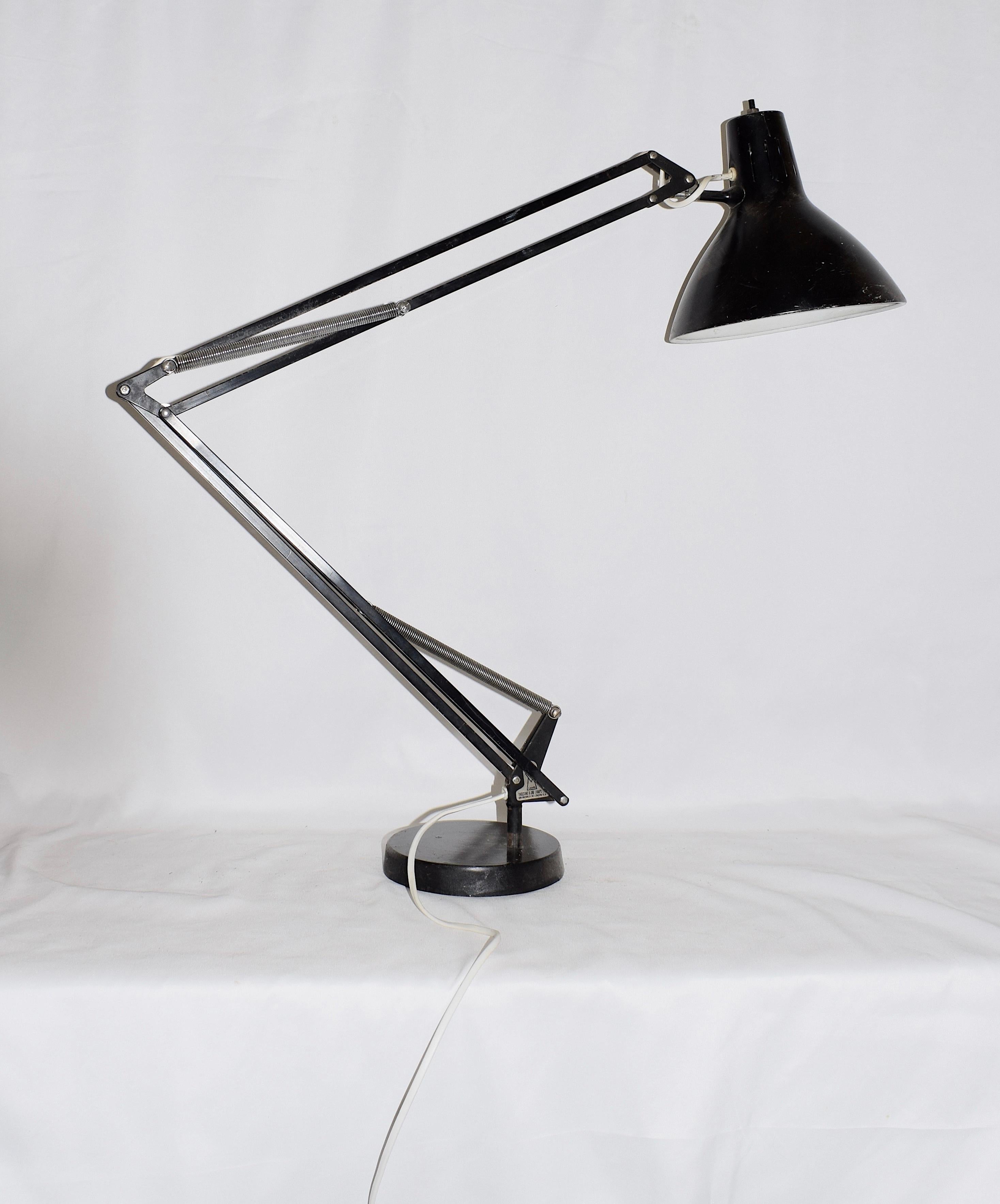 This desk lamp was designed by Herbert Terry during the 1960s. Made by 1001 Lamps Ltd of Bromley Road London, this classic lamp is really well made and heavy. It has its attribution mark of the 1001 Lamp (makers mark) on the inside of the lamp.