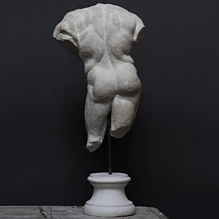 This sculpture is a fragmented copy of the Farnese Hercules that dates back to the early third century AD and is housed in the National Archeological Museum of Napoli. The handmade piece is placed on a rough pedestal creating a fine contrast with