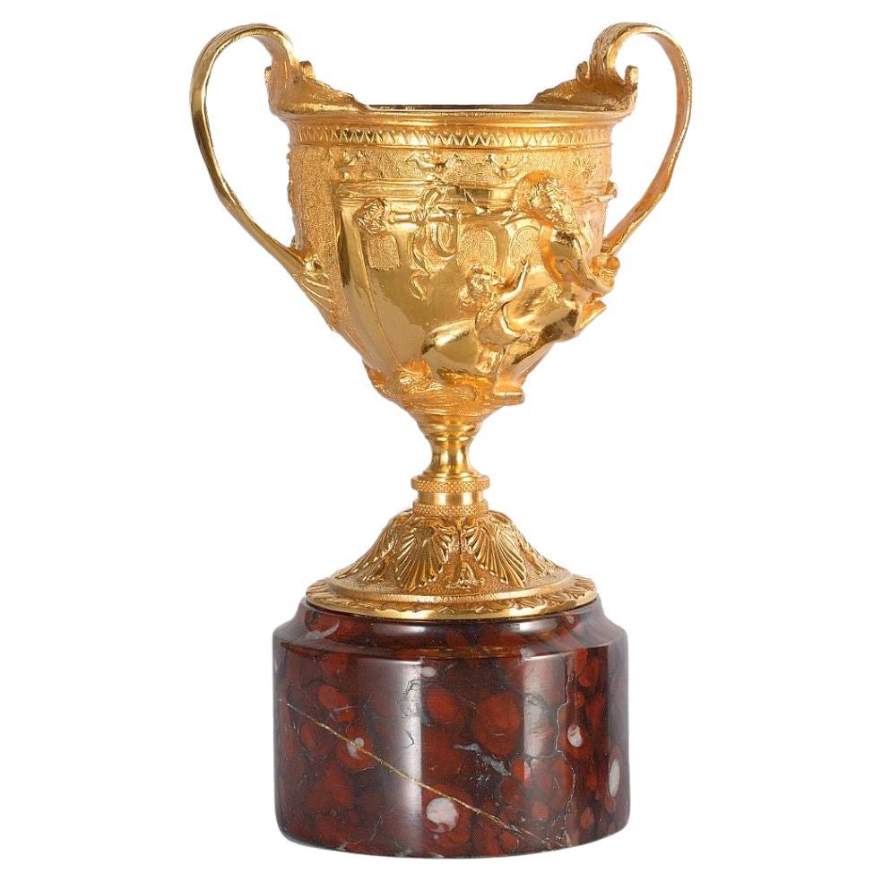 Hercules Satin brass cup with marble base For Sale
