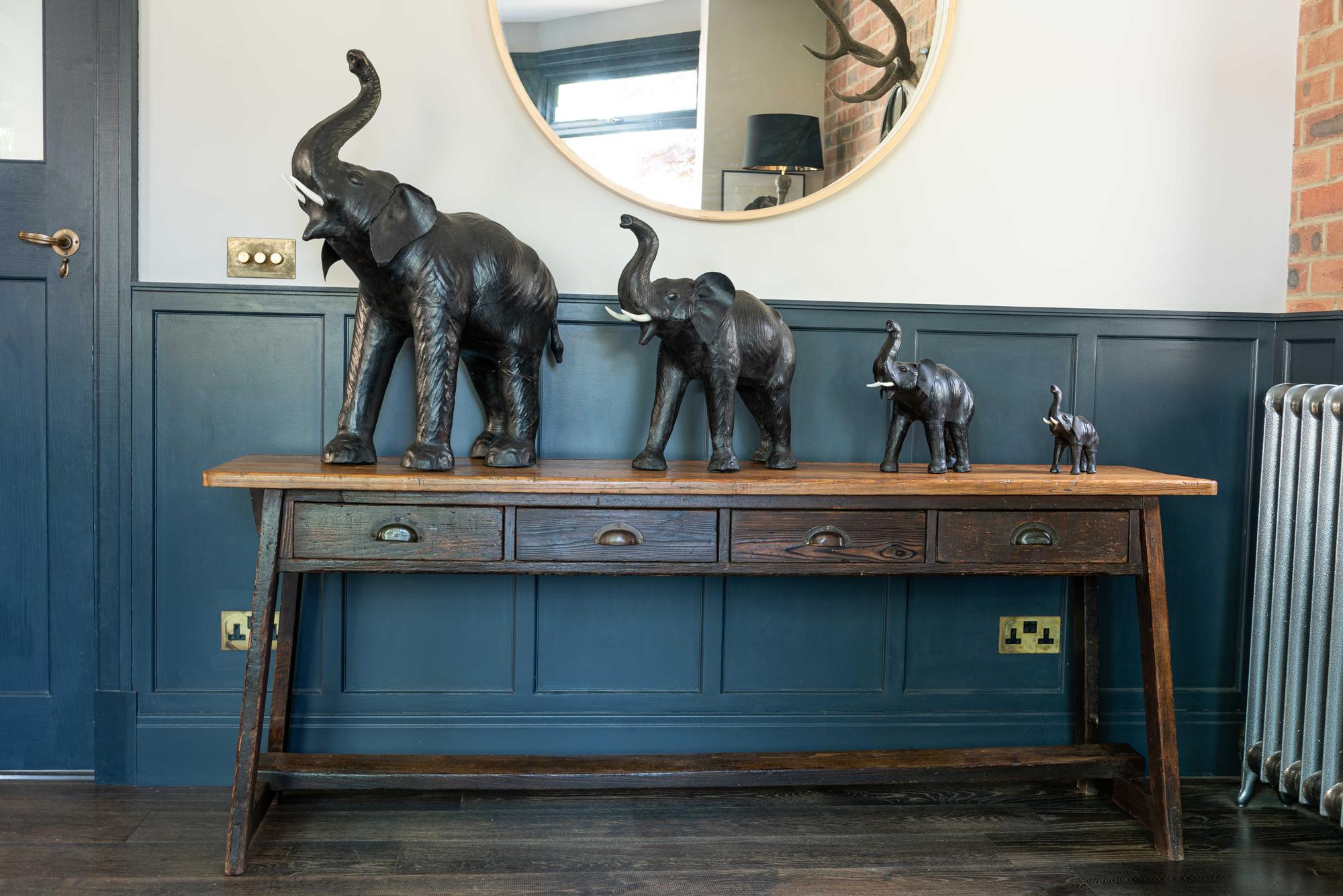 Herd of decorative black/brown leather elephants, mid-20th century.
Decorative collection of leather elephants. Acquired from a private collection.
(The second smallest has had a past repair to his trunk as shown.)

Originally retailed by