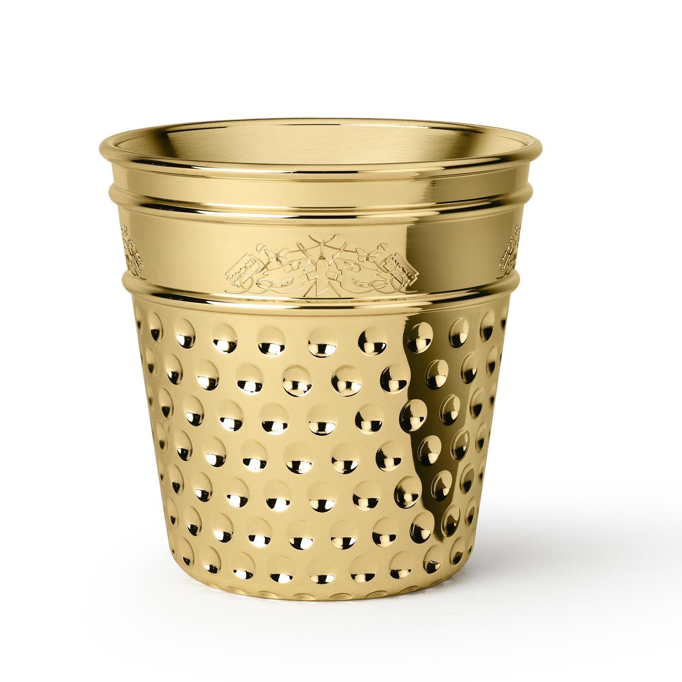 The shape of this exquisite steel ice bucket with a brass finish designed by Studio Job is that of a giant thimble and it is inspired by the family's tailoring tradition. A whimsical etching decorates the top side with butterflies and small