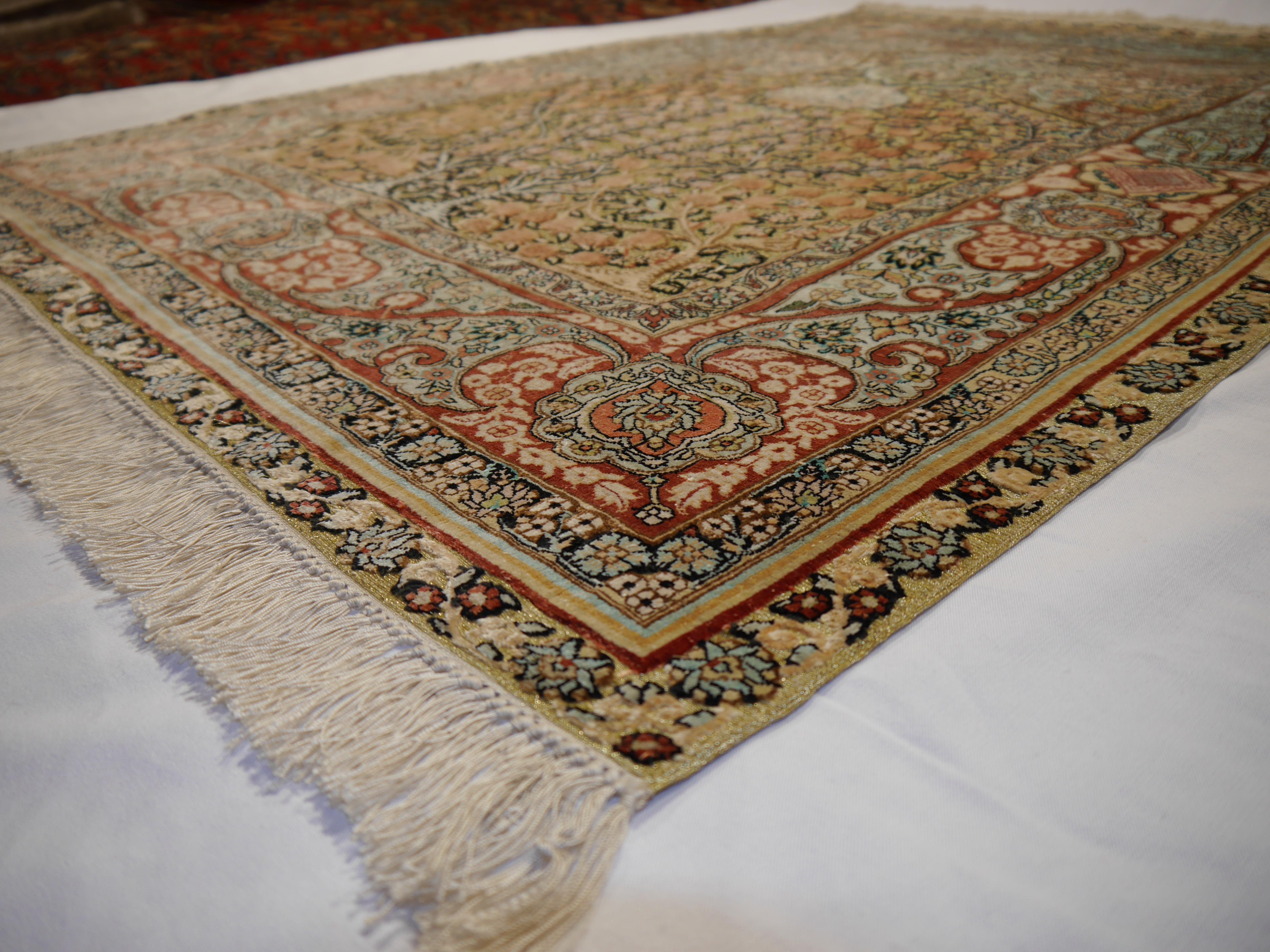 A beautiful Chinese silk souf rug with Hereke design
 
Construction
This decorative rug has a pile made of fine spun 100% pure organic mulberry silk combined with golden colored metal threats. The rug is very fine and dense, it has about 650