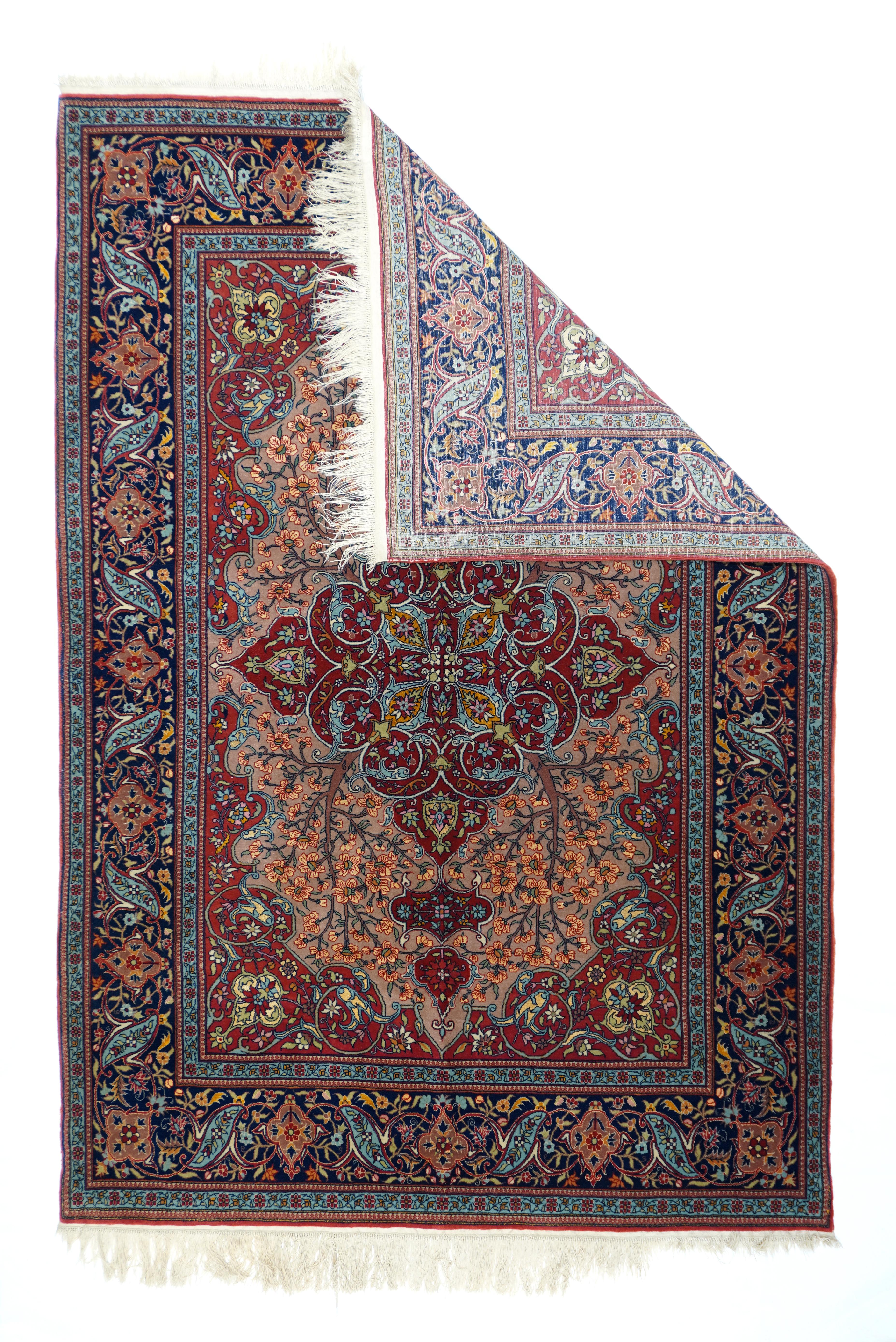 With a composuite wool and silk pile, this very finely woven Turkish medallion scatter woven near Istanbul, shows a red, internally scrolled diamond medallion with double pendants of cartouche and quadrilobe forms. Green field with four flowering
