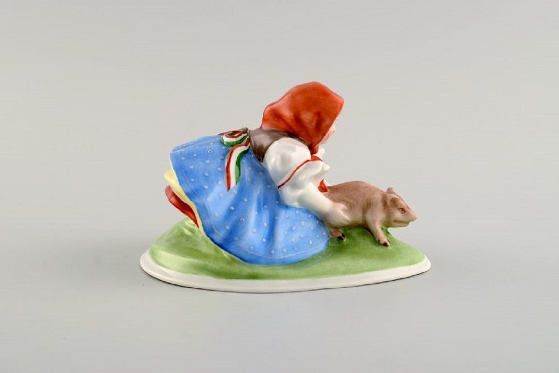 Hungarian Herend Figure in Hand-Painted Porcelain, Peasant Girl with Piglet, Mid-20th C.