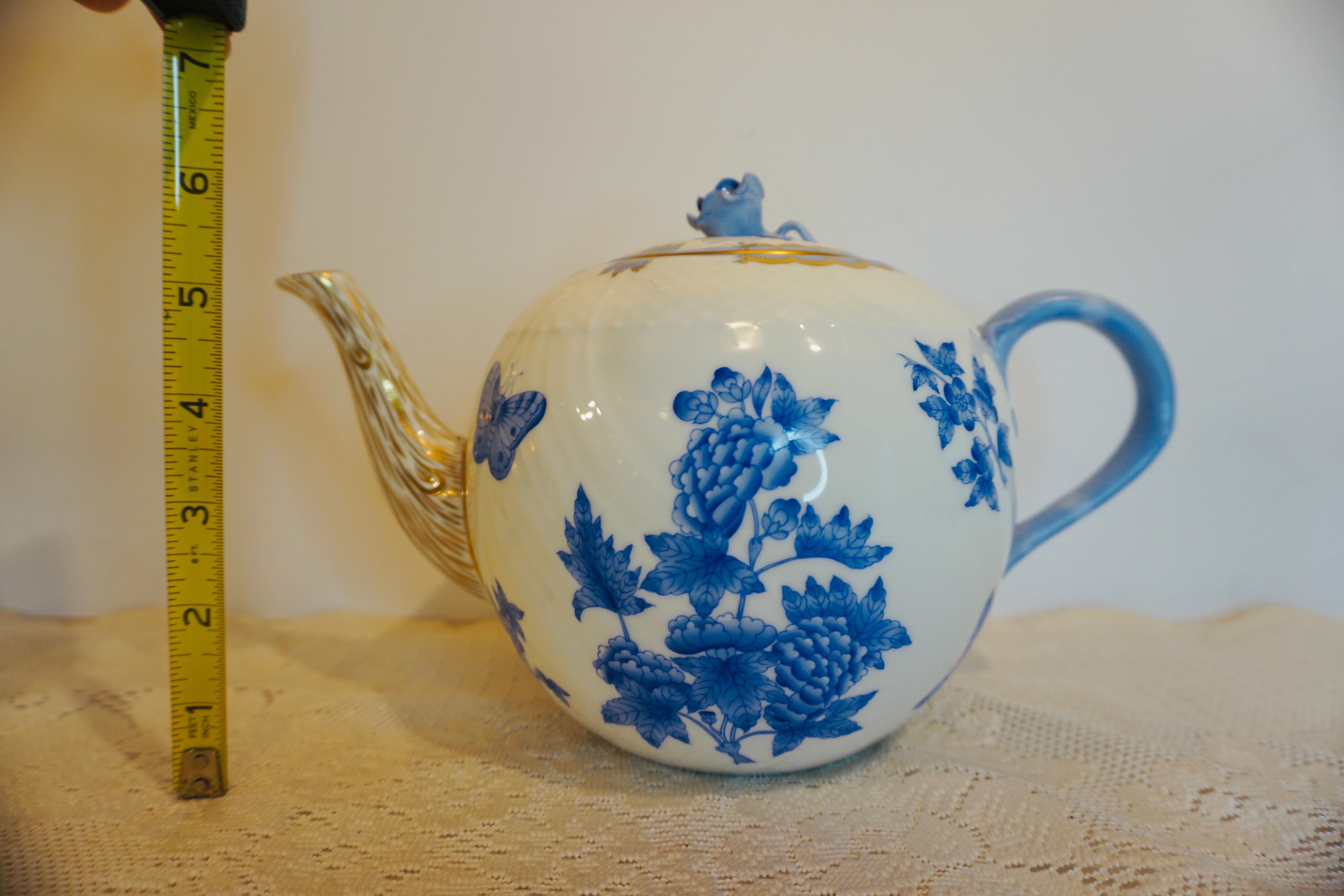 I am proud to offer you this wonderful blue and white Herend teapot in the Fortuna pattern beautifully hand-painted with butterflies and flowers. It was made in Hungary by the renown Herend Porcelain Manufactory.  It has a charming blue raised