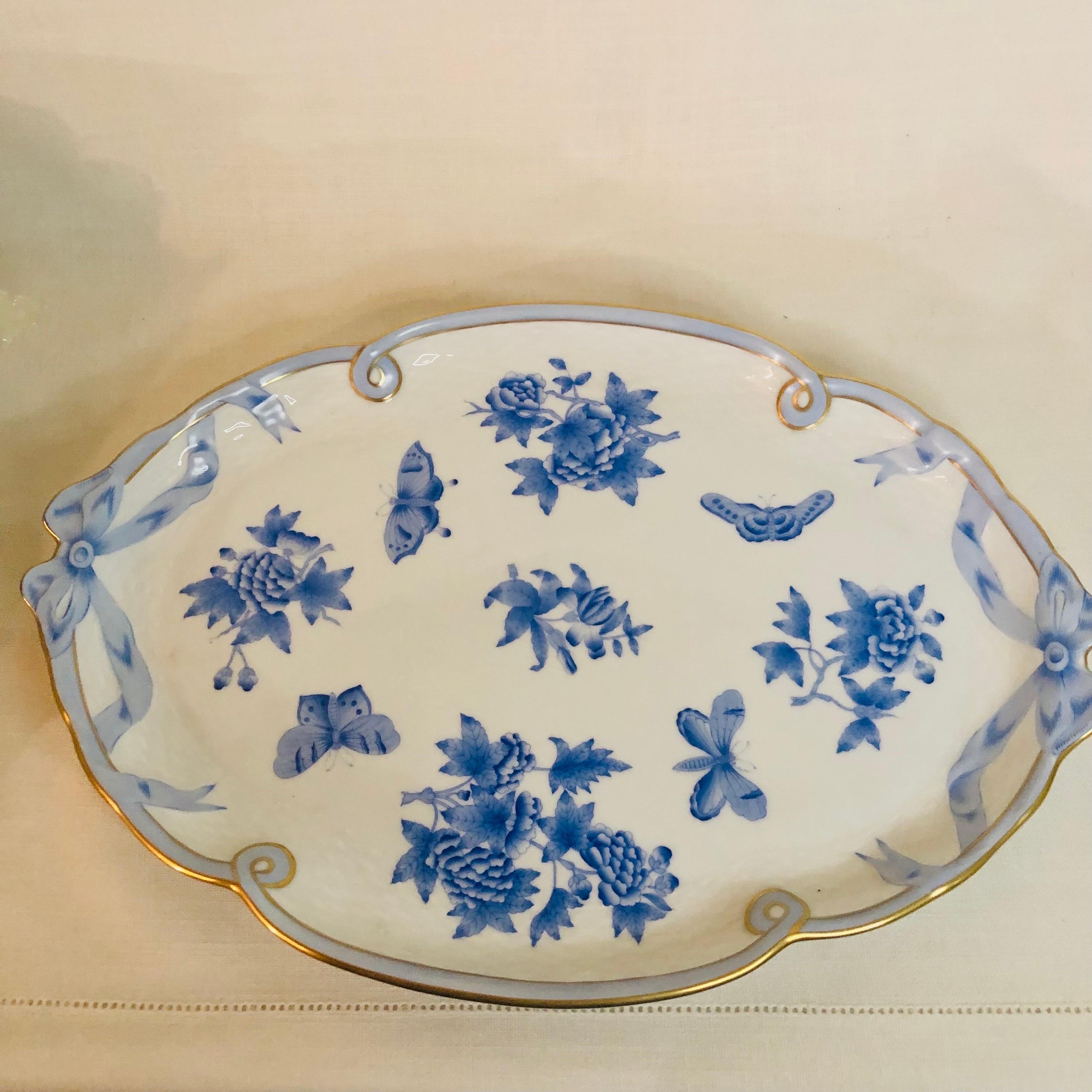 This is a stunning Herend Fortuna serving or tea or coffee tray with bow handles. This tray is sixteen inches wide and is hand-painted with blue butterflies and flowers on a white background with 24 karat gold accents. I can see this as a tea or