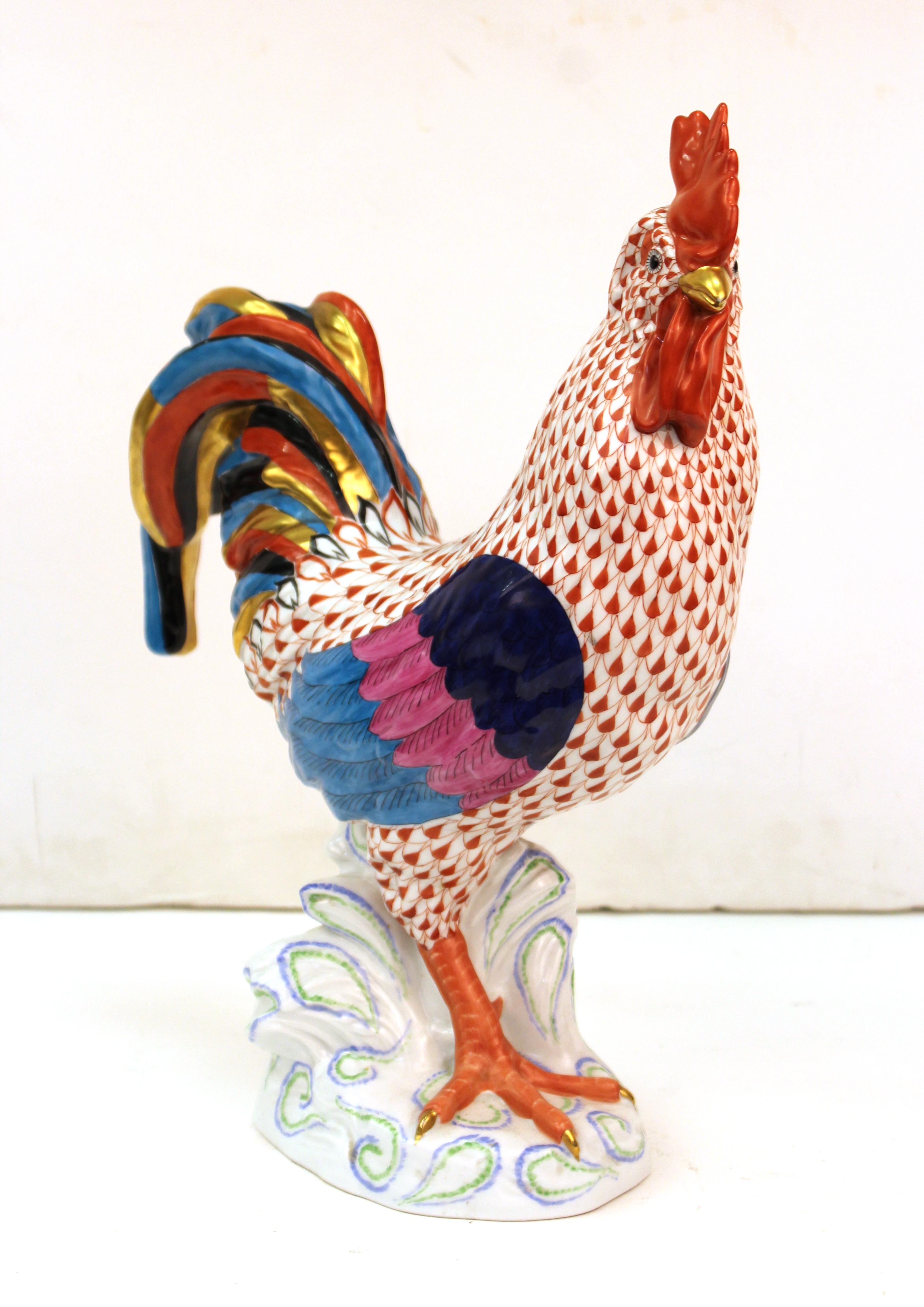 Hungarian hand painted porcelain rooster sculpture, made by Herend. The piece has multicolored feathers and has a makers mark on the bottom as well as a 'Herend' stamp and numbers. In great vintage condition with age-appropriate wear and use.