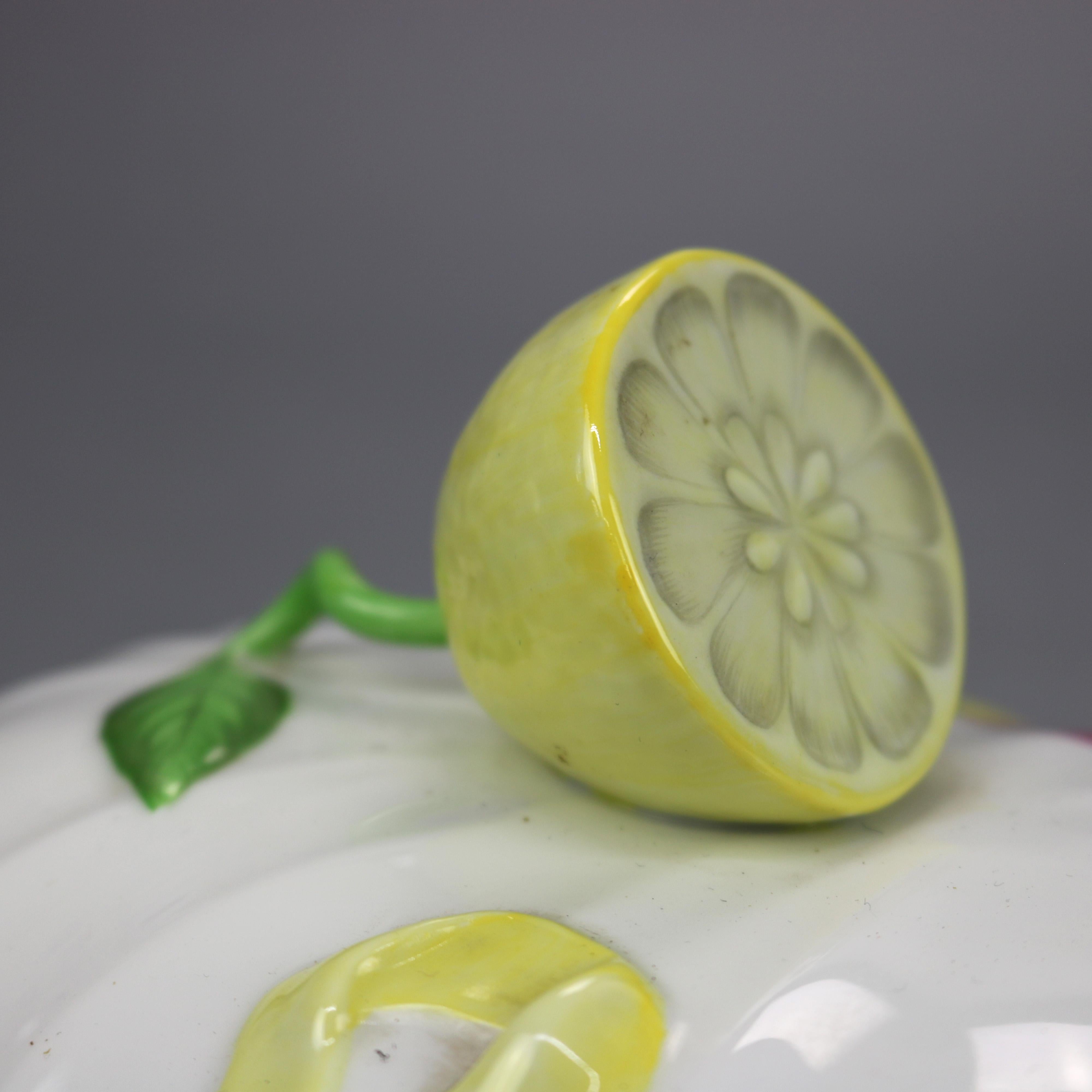 A porcelain tureen by Herend of Hungary offers double handled lidded bowl having lemon form handle and underplate, handpainted with detached floral design and gilt highlights, maker stamp as photographed, 20th century

Measures: Tureen- 5