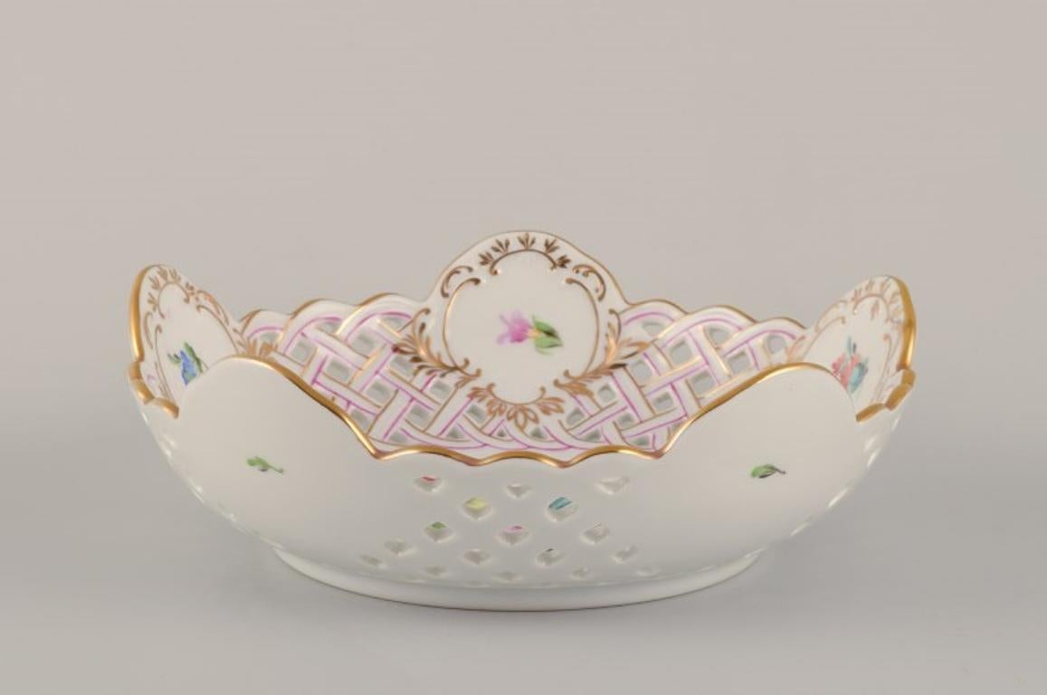 Herend, Hungary. Open lace porcelain bowl with hand-painted polychrome flower motifs and gold decoration.
Mid-20th century.
Marked.
In perfect condition.
Dimensions: Diameter 18.5 cm x Height 6.0 cm.