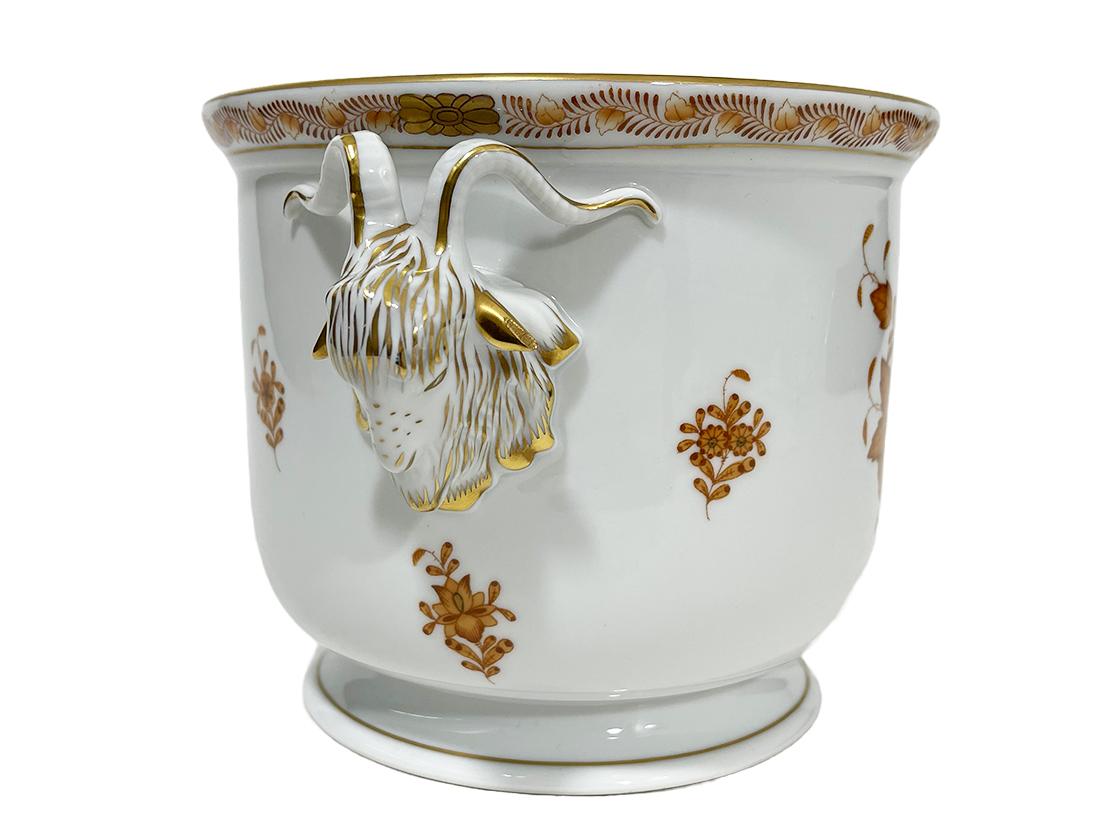 Herend Hungary porcelain apponyi brown ram head cachepot.

Herend Hungary porcelain cachepot in pattern Apponyi Brown with ram heads as handles
Marked with the Herend porcelain mark used during 1960-1980 and numbered with 7283/ AM 
AM is for
