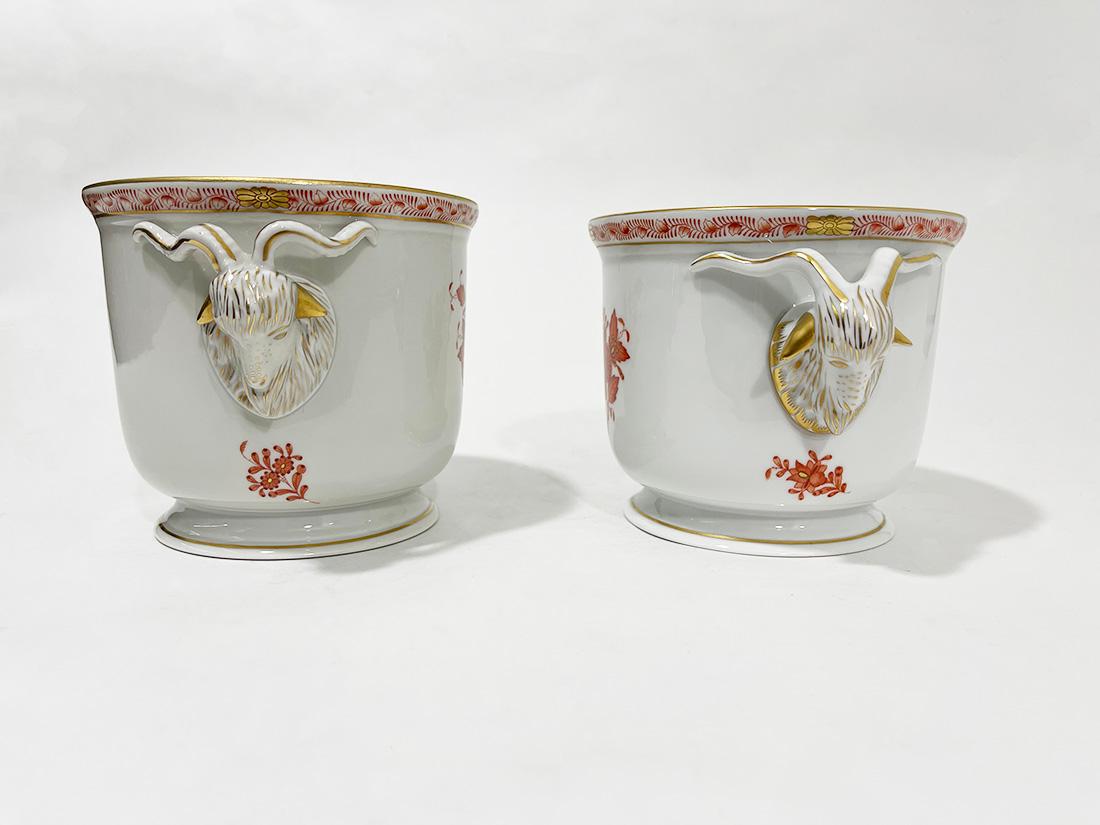 Herend Hungary porcelain apponyi orange ram head cachepots

Herend Hungary porcelain cachepots in pattern Apponyi orange with ram heads as handles
Marked with the Herend porcelain mark used during 1960-1980 and numbered with 7284 and 7384/AOG . The