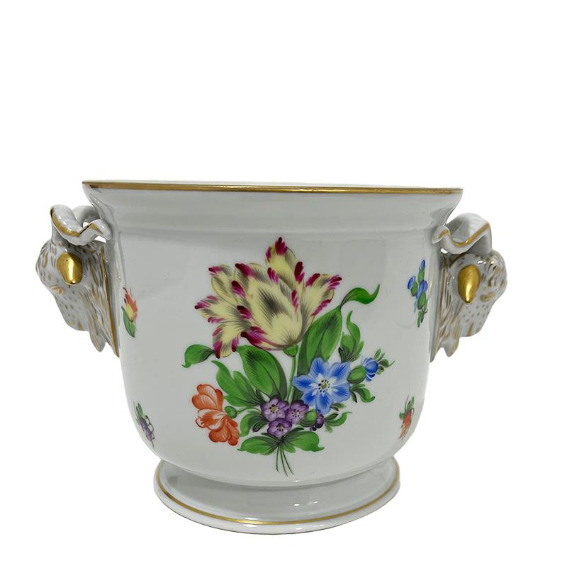 Herend Hungary Porcelain Bunch of Tulip pattern Ram Head Cachepot

Herend Hungary porcelain cachepot in pattern Bunch of Tulip with ram heads as handles
Marked with the Herend porcelain mark used during 1960-1980 and numbered with 7284/ BT
BT is for