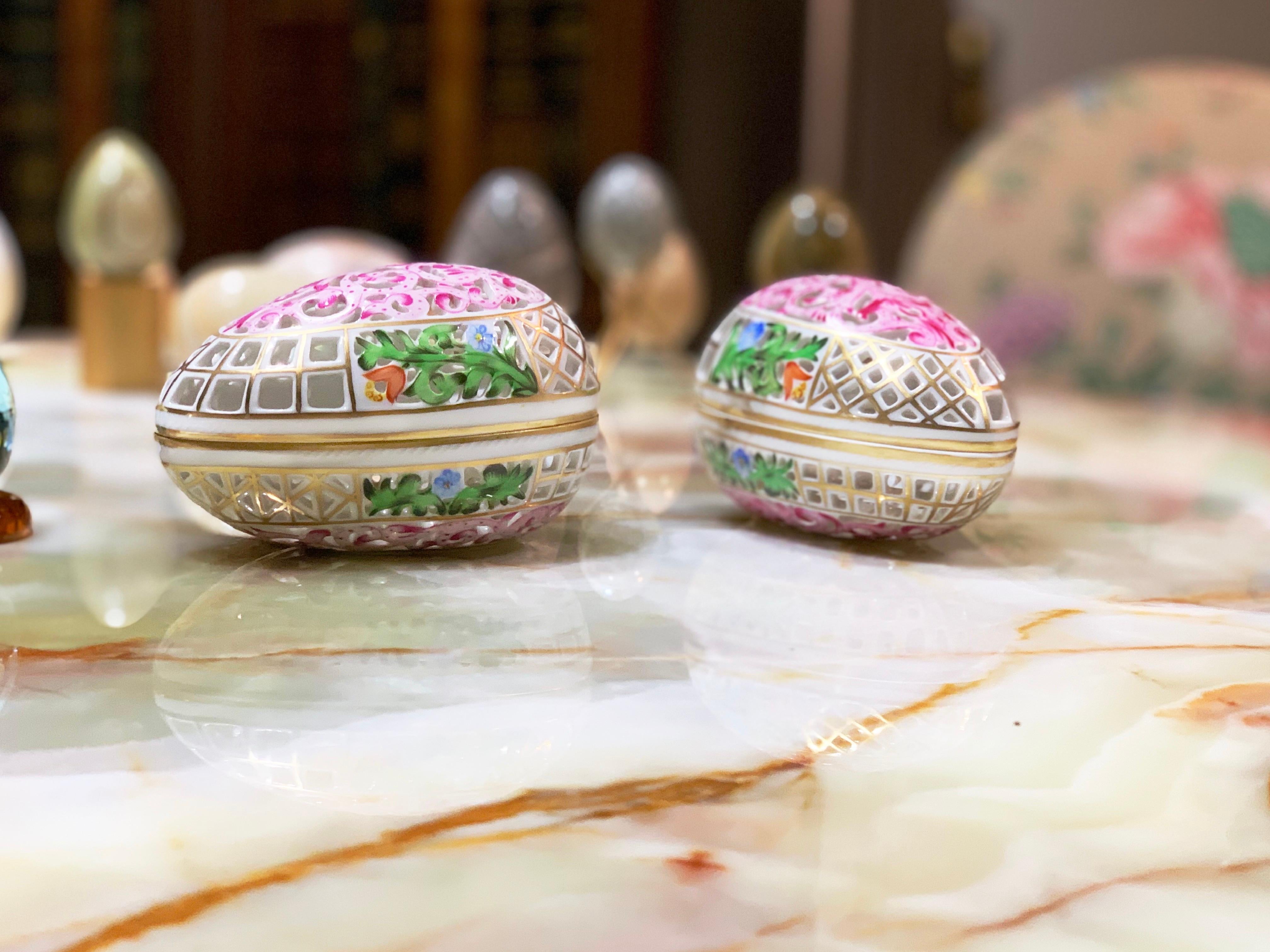Gorgeous pierced egg-shaped box by Herend of Hungary. Gilded and hand painted with pink floral design. Measures: Height 3