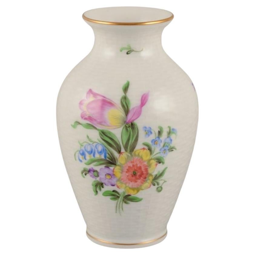 Herend, Hungary. Porcelain vase hand-painted with polychrome flower motifs