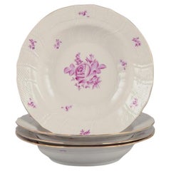 Herend, Hungary. Set of four deep plates with purple floral motifs