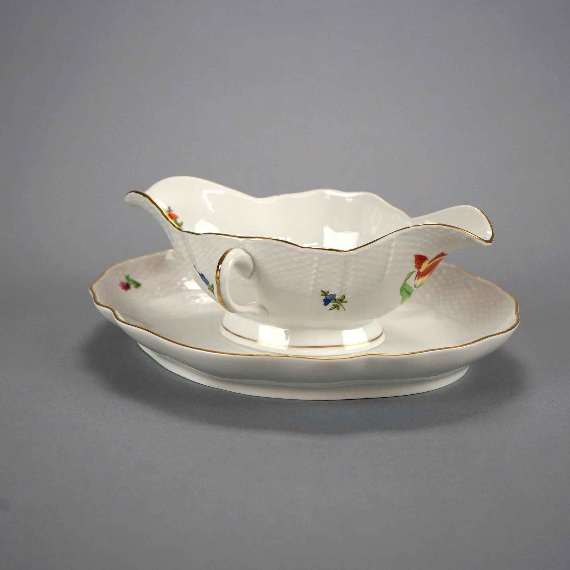 A gravy boat by Herend offers porcelain construction with painted flowers, gilt highlights, double handles and underplate, maker mark on base as photographed, 20th century

Measures- 3.75''H x 8.25''W x 10.25''D.

Catalogue Note: Ask about