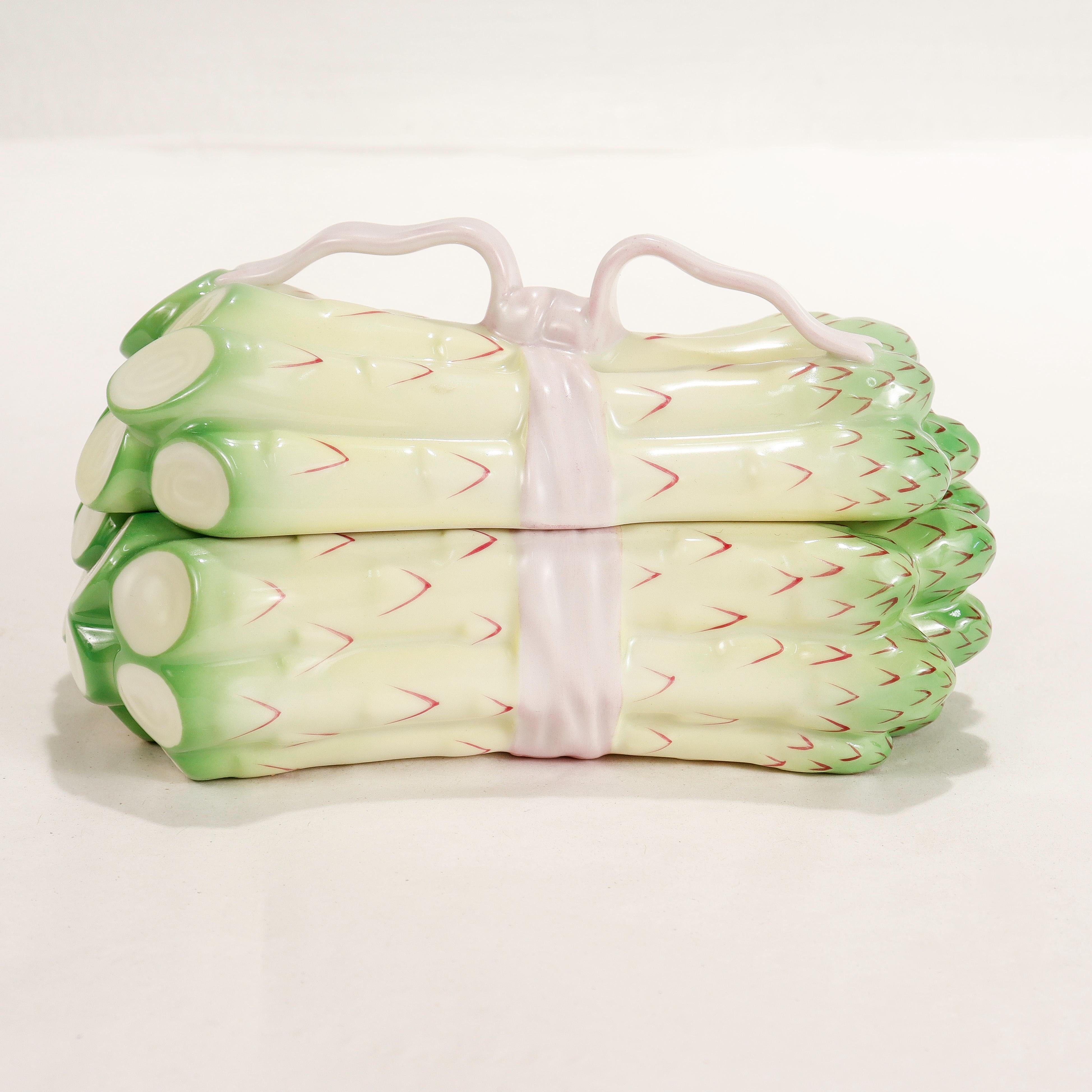 A fine figural porcelain covered box.

By Herend.

In the form of a bundle of asparagus tied together with a pink ribbon.

Model No. 6070/C.

Simply a wonderful piece of Herend porcelain!

Date:
20th Century

Overall Condition:
It is