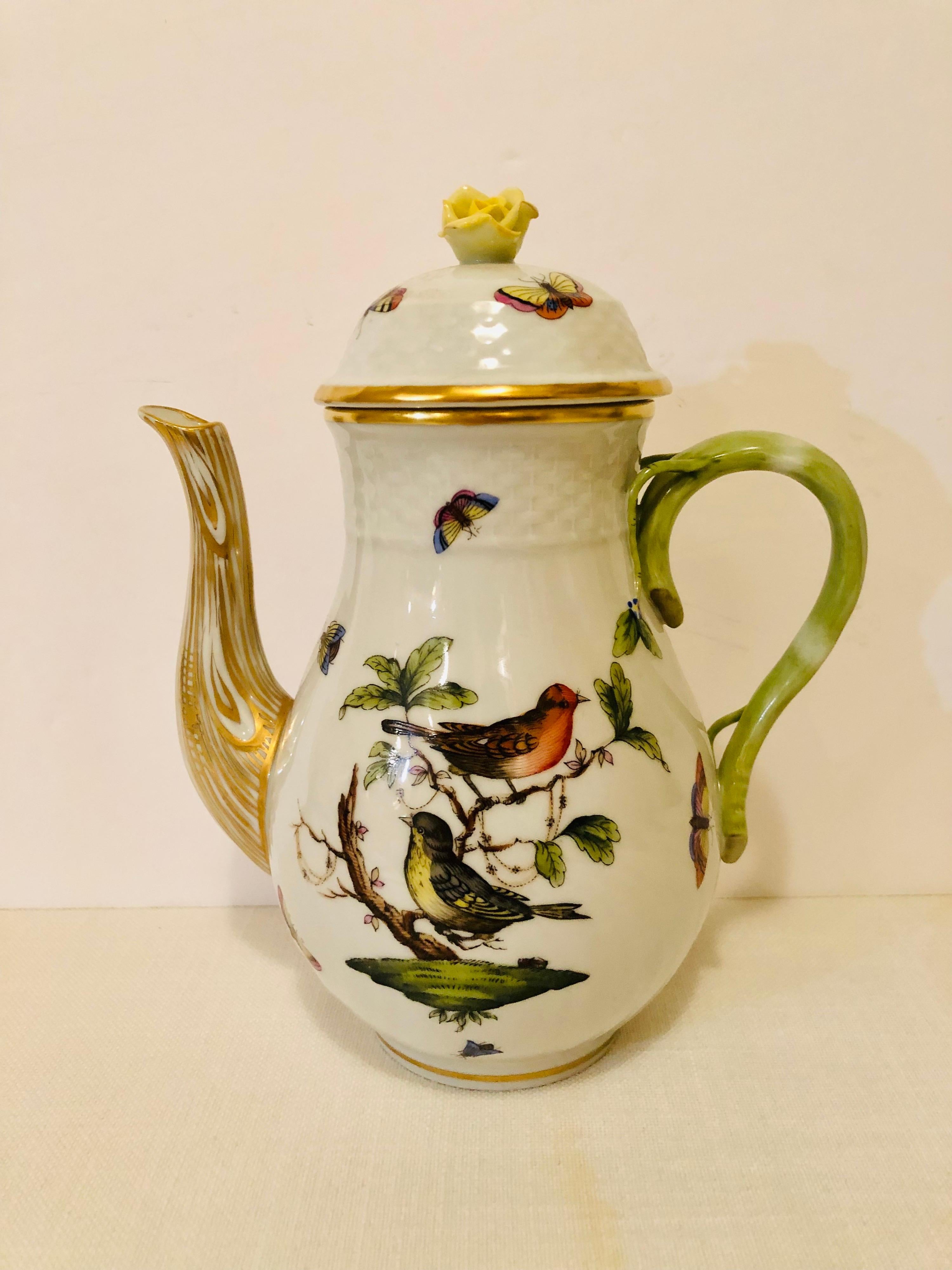 This is a beautiful Herend Rothschild bird coffee pot hand painted with two birds on both sides, and decorated with butterflies and insects on a white ground. The top of the coffee pot has a raised beautiful yellow rose painted with accents of