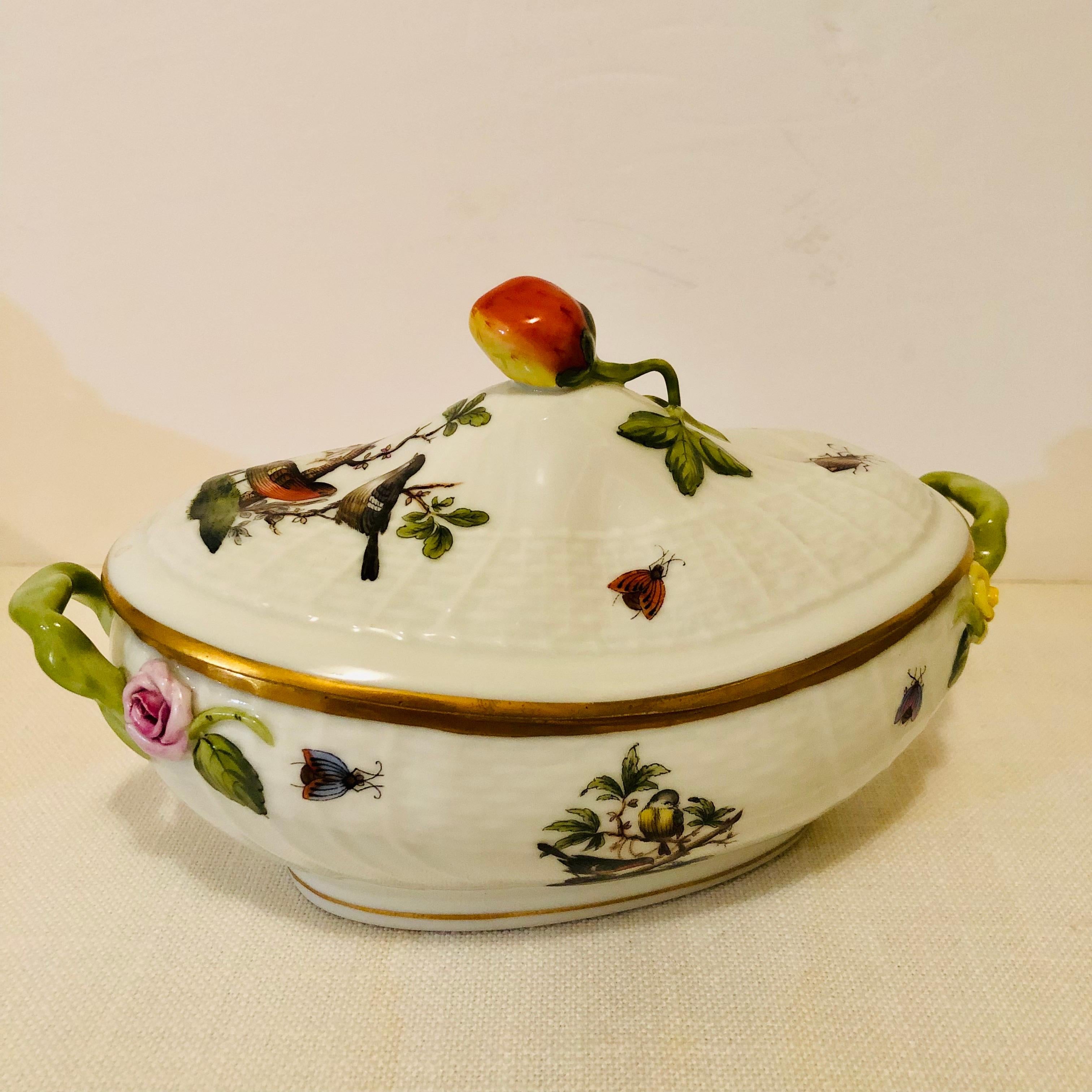 This is a wonderful Herend Rothschild bird sauceboat hand painted with birds with colorful accents of butterflies and insects on a white ground. The top is painted with a pair of birds surrounded by colorful insect and butterfly decoration with a
