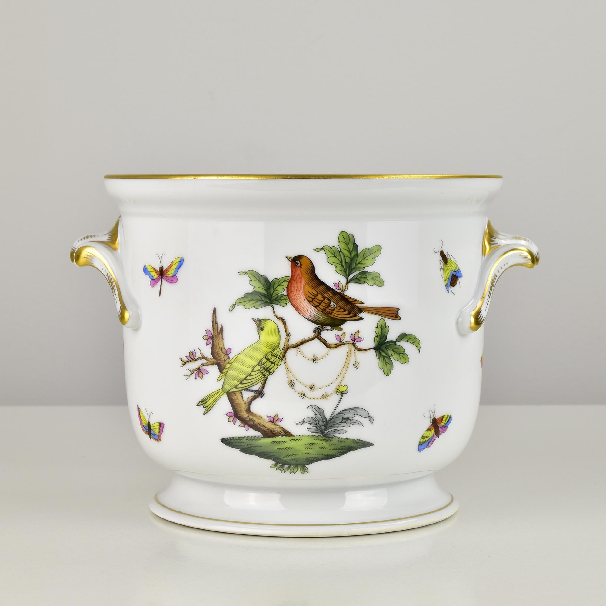 Exquisite Herend Hungary porcelain cachepot from the famous Rothschild Bird pattern, featuring hand-painted songbirds perched on leafy branches, surrounded by colorful butterflies and insects. Crafted in fine white porcelain, the design is enriched