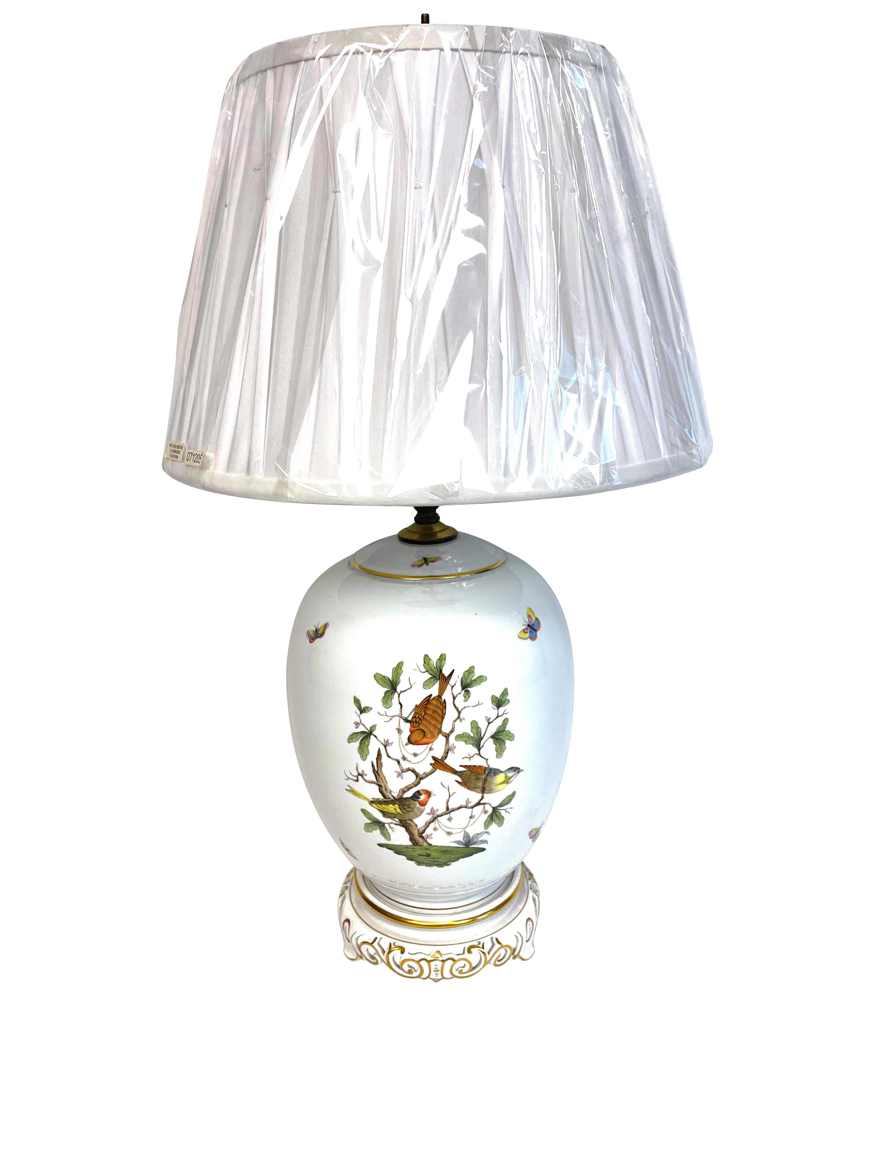 This famous pattern, created in the 1860s for the Baron de Rothschild family, is considered by many to be the paragon of hand-painting on porcelain. This majestic lamp is handmade and hand-painted in Hungary, with an open-work and gold rimmed base.