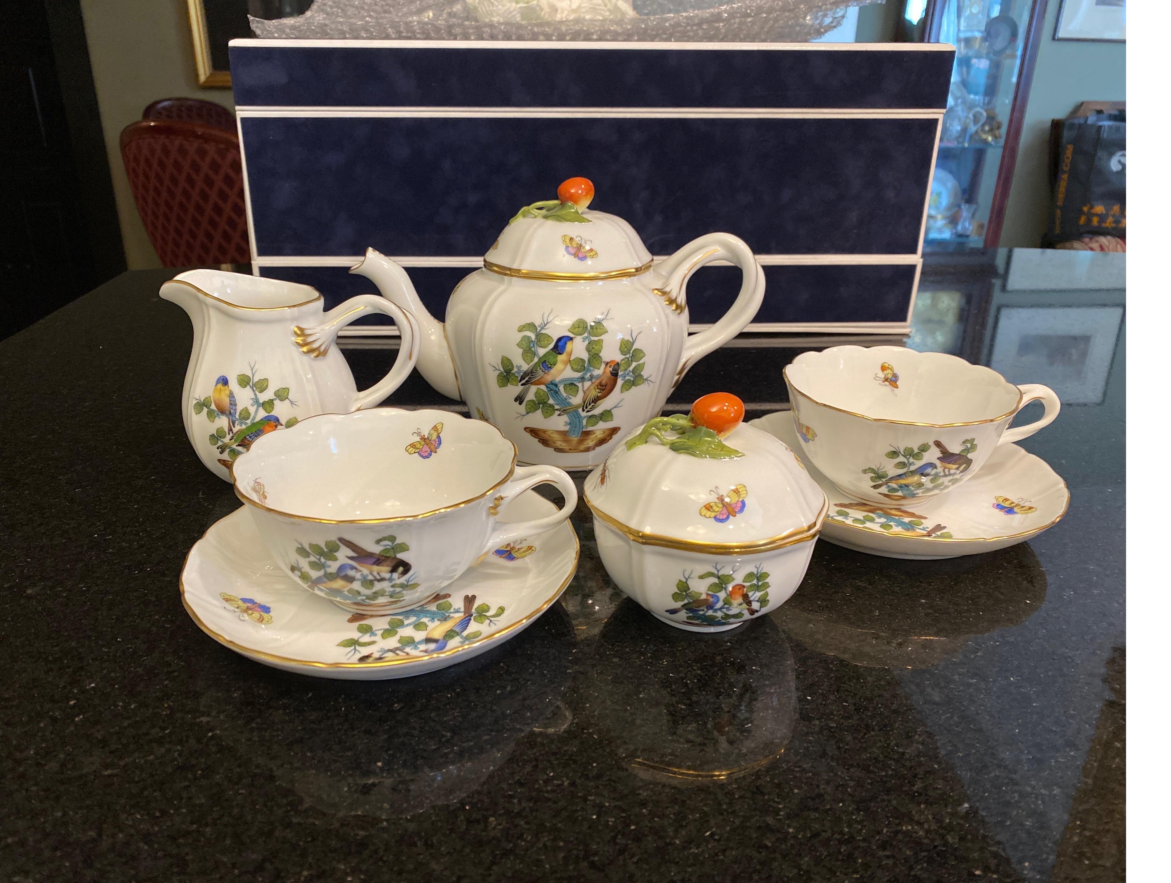 Hand painted Herend tea set in the Rothschild bird pattern. The teapot, sugar, creamer, two tea cups and two saucers with hand painted birds, butterflies and insects. The cost is for the entire set. Teapot is 6 high 8.75 wide, sugar is 3.75 high,