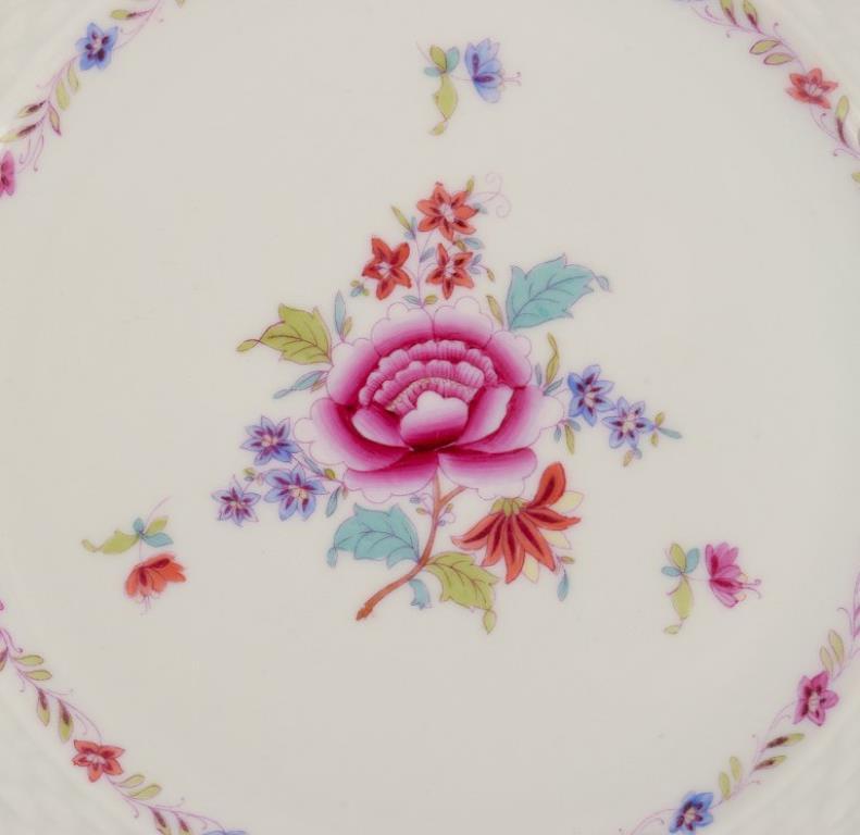 Hungarian Herend, set of twelve porcelain plates with polychrome floral motifs. For Sale