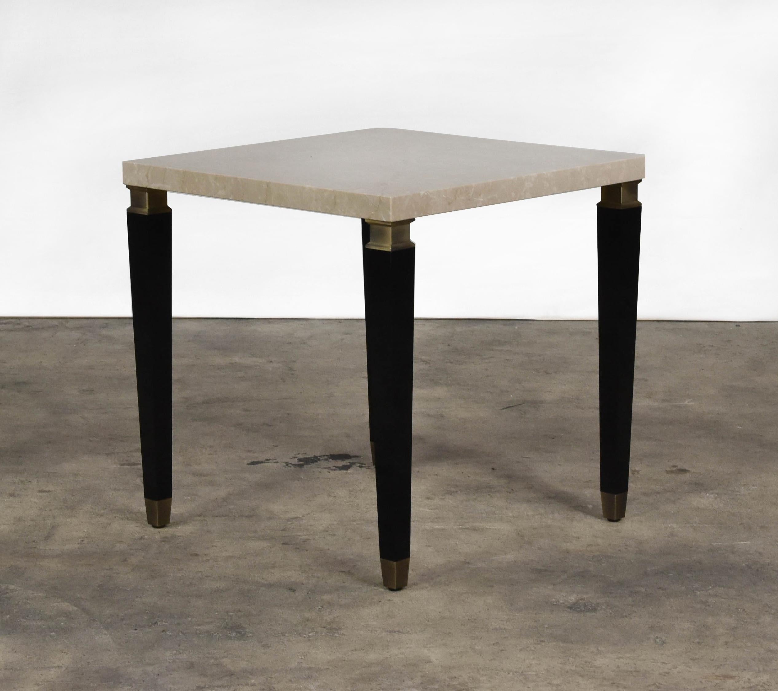 The Nest coffee table features botticino marble top, black lacquered legs and brushed brass detail.
 