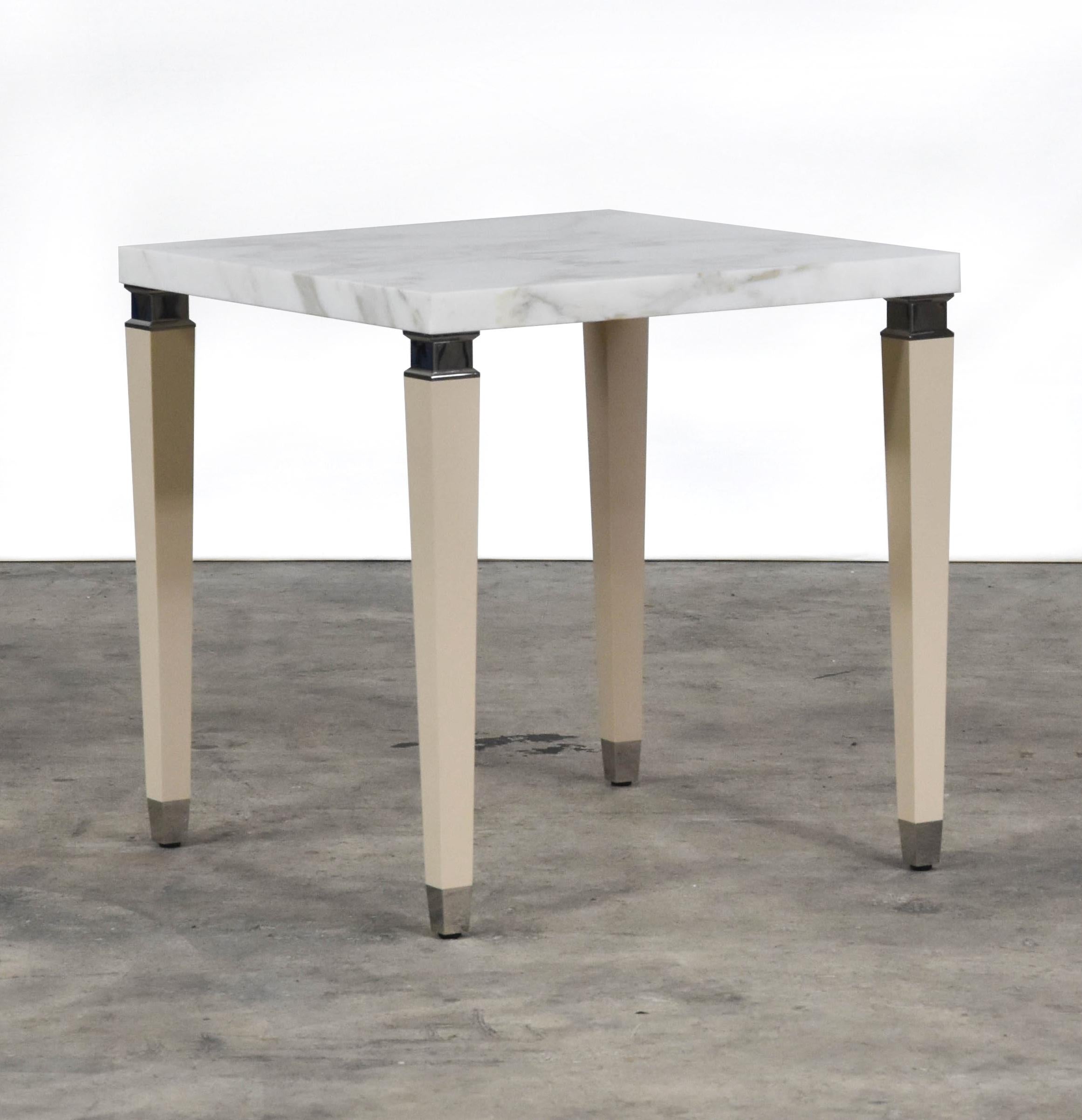 The nest coffee table features calacatta marble top, sand colored leather legs with steel accents.
  