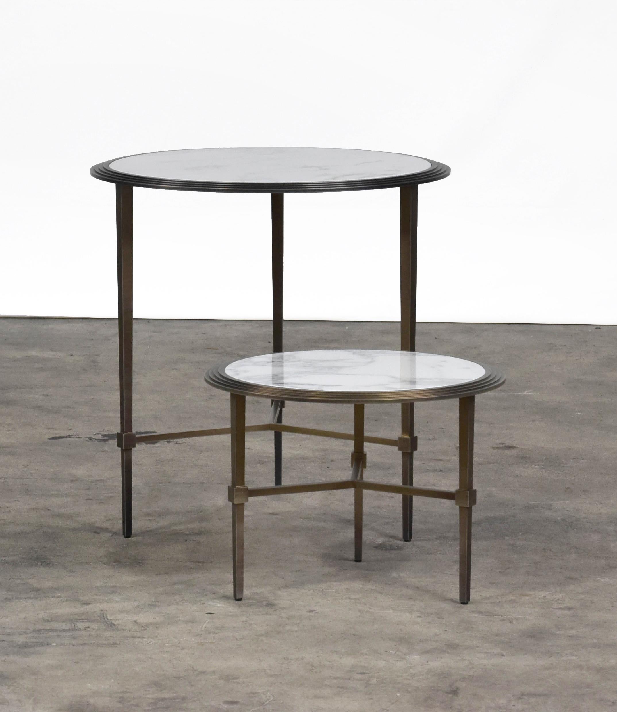The Saturno coffee tables are a series of round coffee tables available in different heights and dimensions to create layered compositions. Base color is brushed bronze with Carrara marble top. Diameter combination of 14 and 20 inches.
  