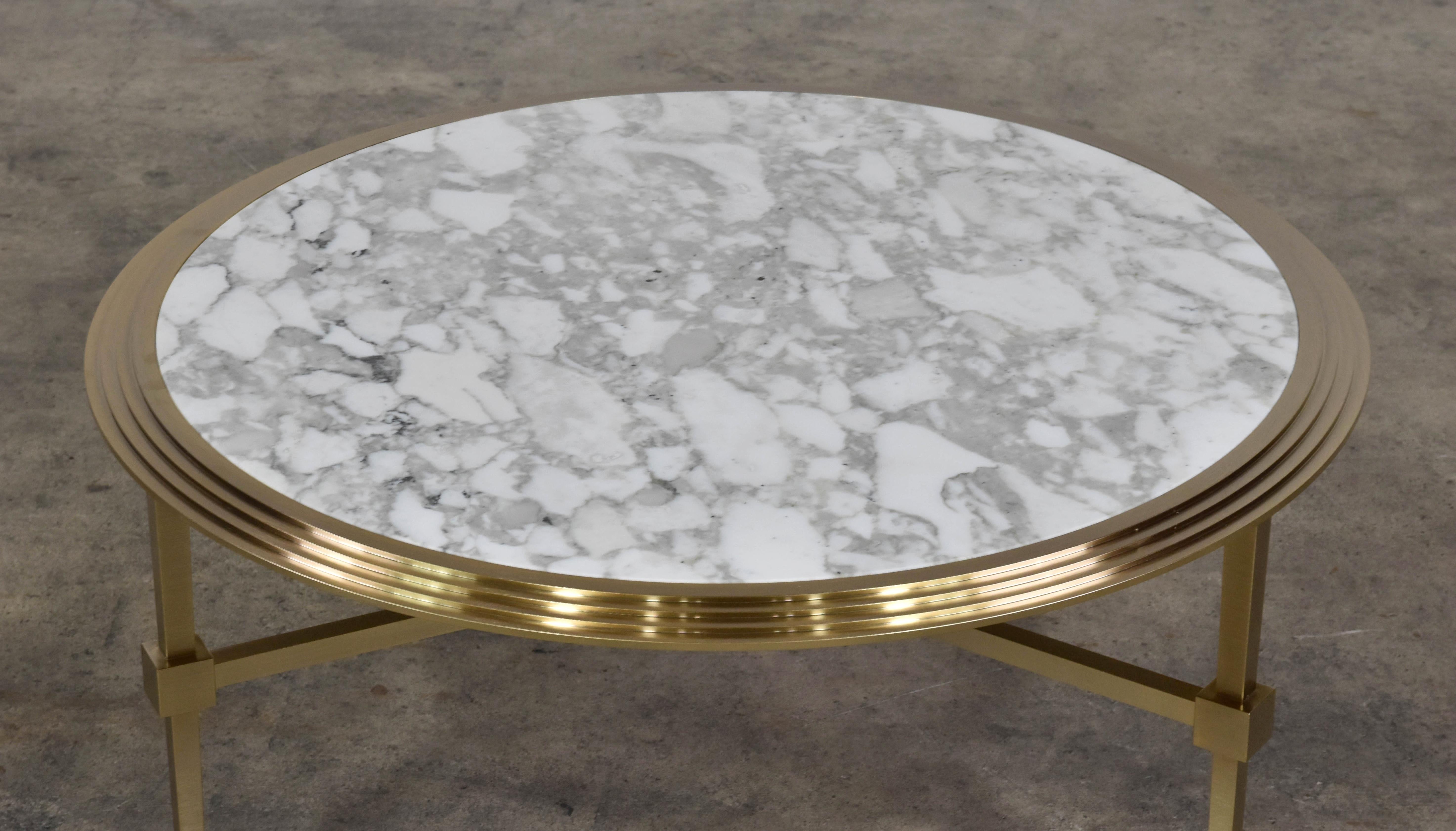 The Saturno coffee tables are a series of round coffee tables available in different heights and dimensions to create layered compositions. Base color is brushed bronze with Carrara marble top. Measure: D 35.
 