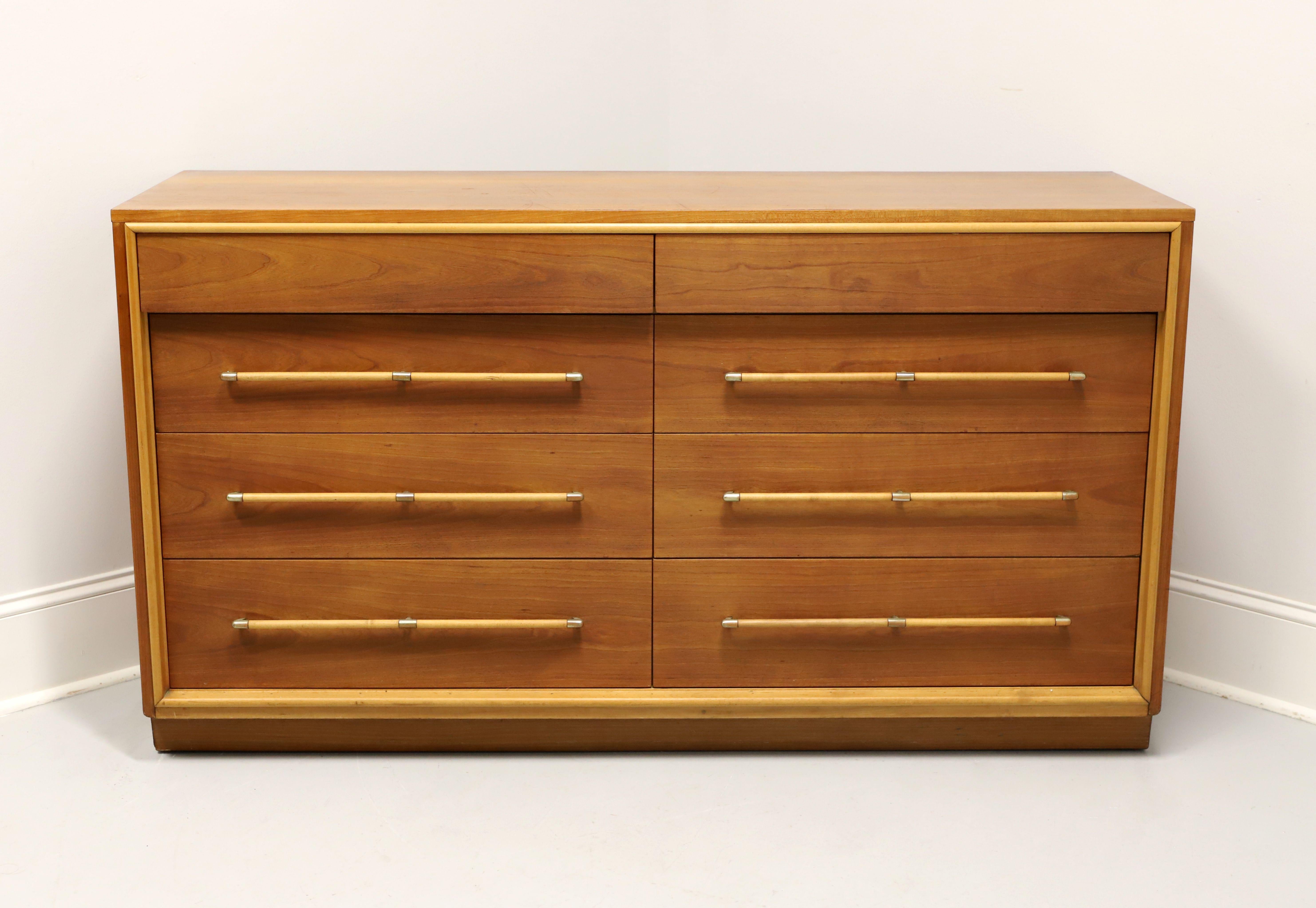 A Mid 20th Century Modern style double dresser by Heritage Henredon, a collaboration between Henredon and Drexel Heritage. Walnut with brass & walnut hardware, solid edge to the top, slightly recessed inward lower drawers, and a solid base. Features