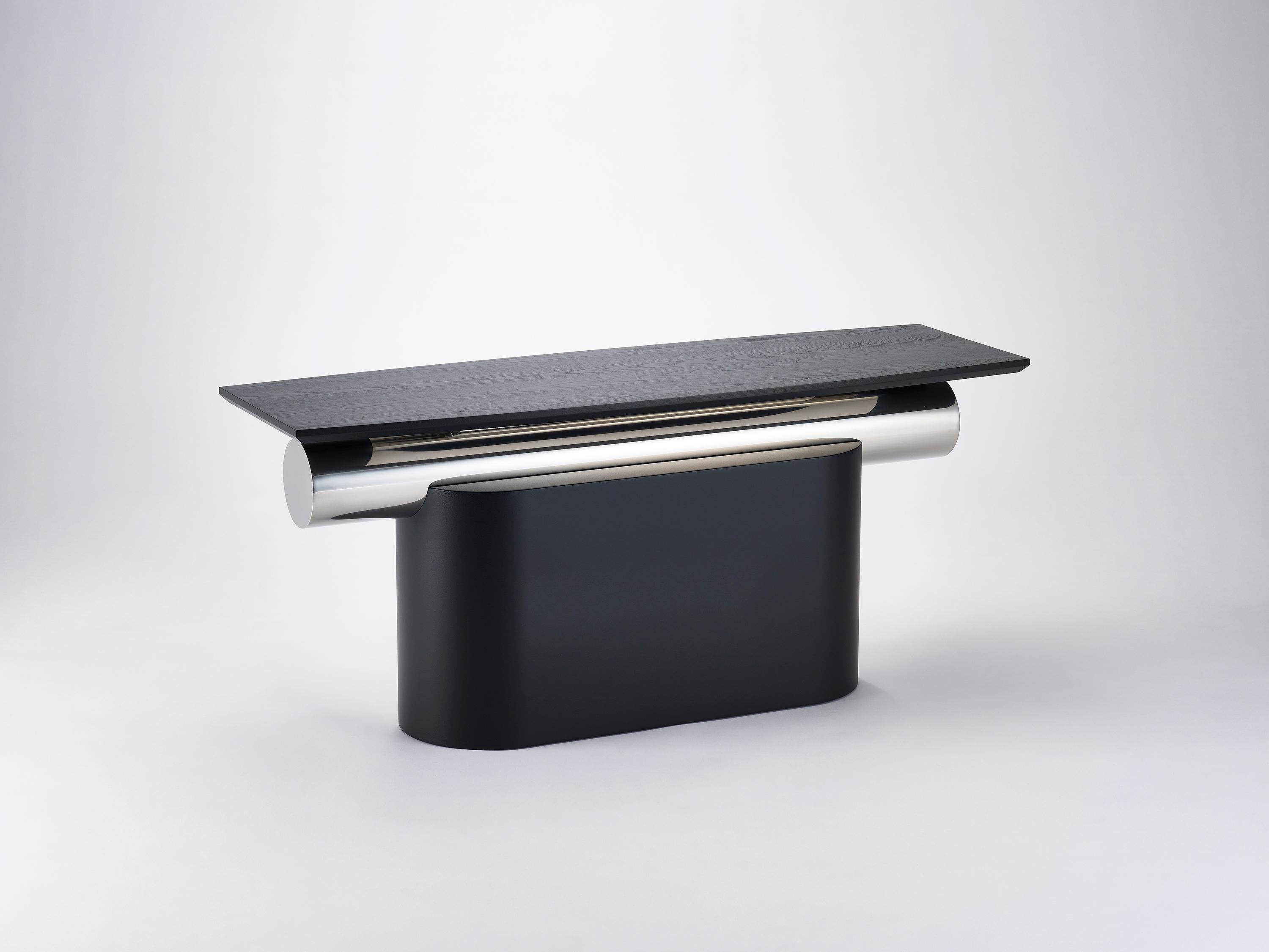 Heritage Layer Curve Table by Lee Jung Hoon
Dimensions: D 34 x W 104.5 x H 45.1 cm
Materials: Steel, Ash, Stainless Steel.

The Heritage series, created by designer Lee Jung-hoon is a collection of sculptural modern furniture. The designs are