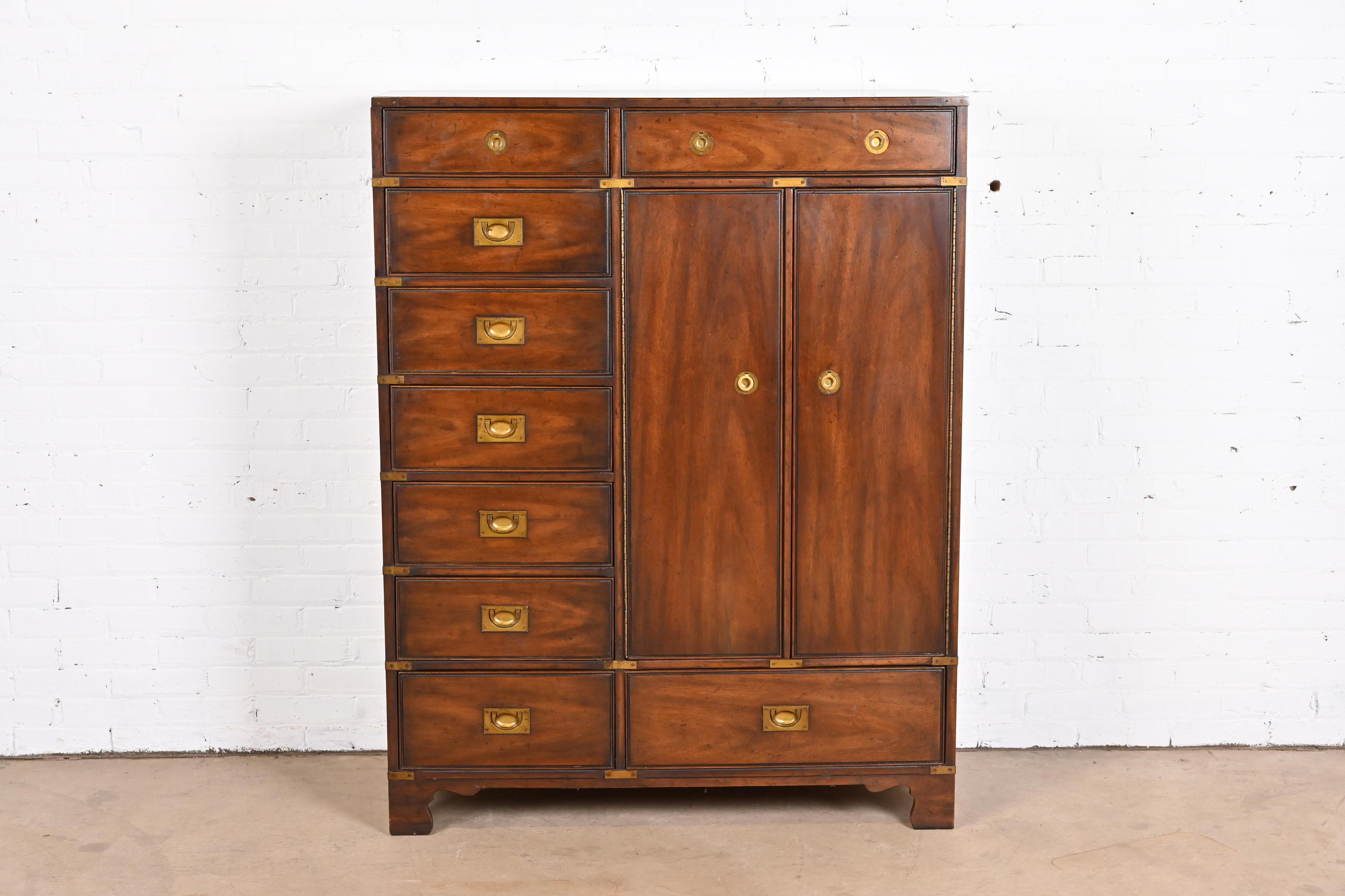 A gorgeous Mid-Century Modern Hollywood Regency Campaign style gentleman's chest or highboy dresser

By Heritage Furniture

USA, Circa 1970s

Walnut, with original brass hardware.

Measures: 44