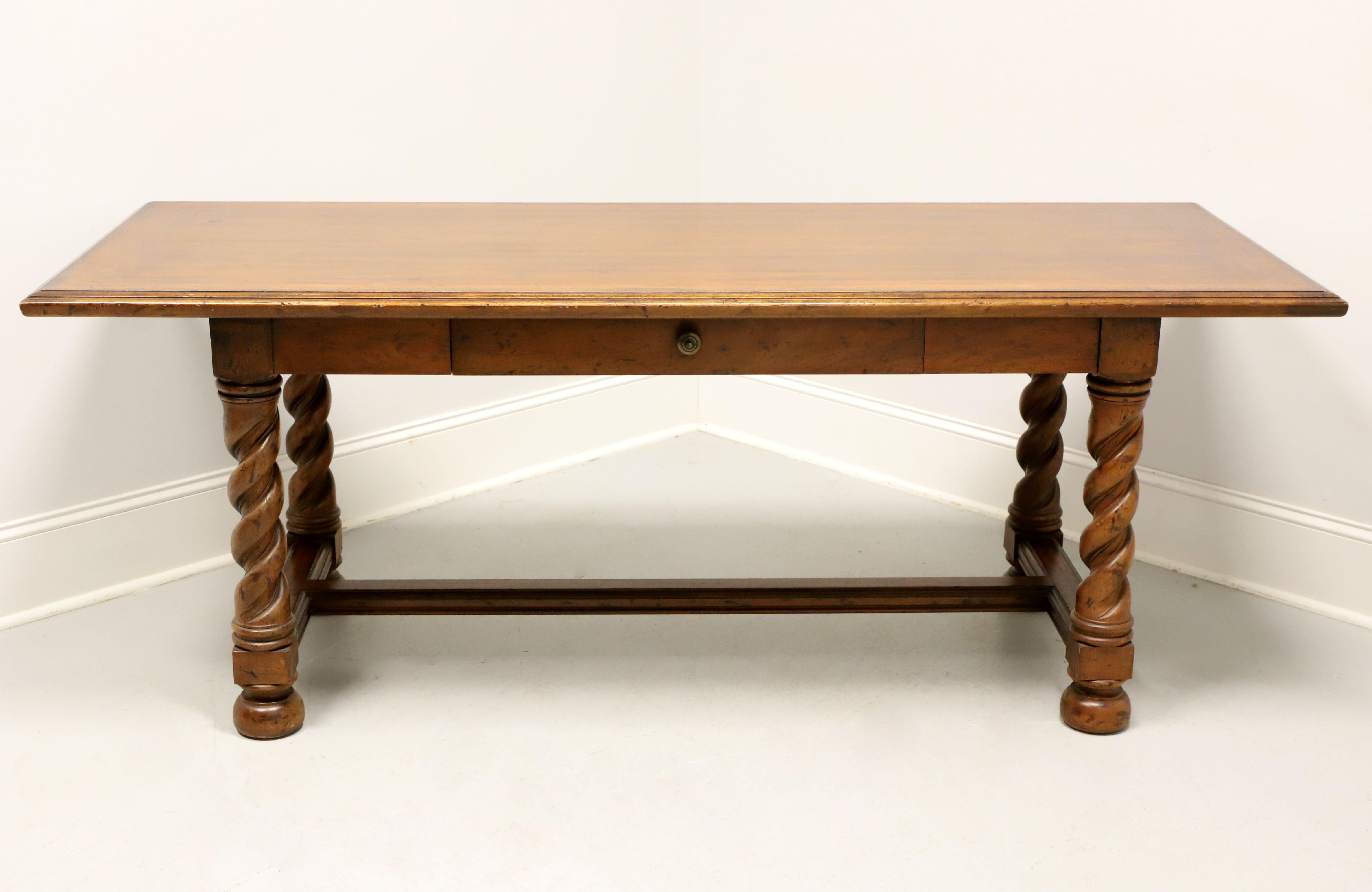 An English Tudor style writing desk by Heritage Furniture. Walnut with banded bevelled edge top, brass hardware, 