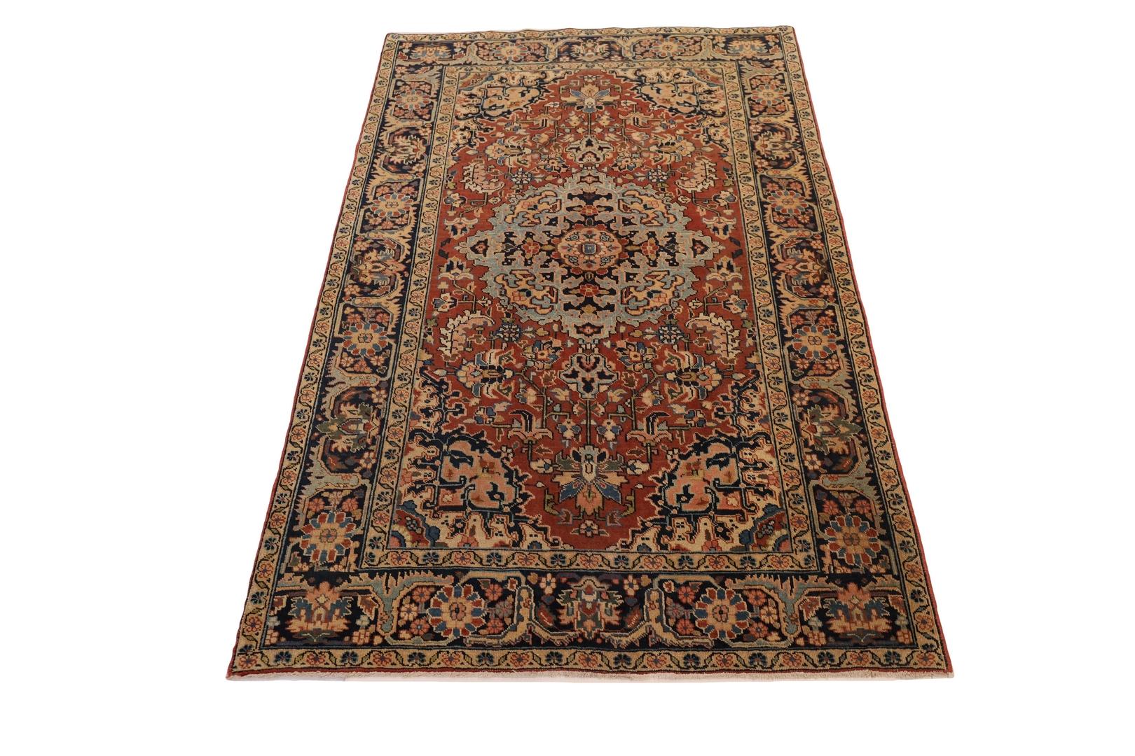 The Heriz rug is a stunning example of traditional Persian weaving, characterized by its bold and striking design. At the heart of the rug lies a beautiful light-blue medallion, adorned with intricate designs in colors of pink, red, blue, light